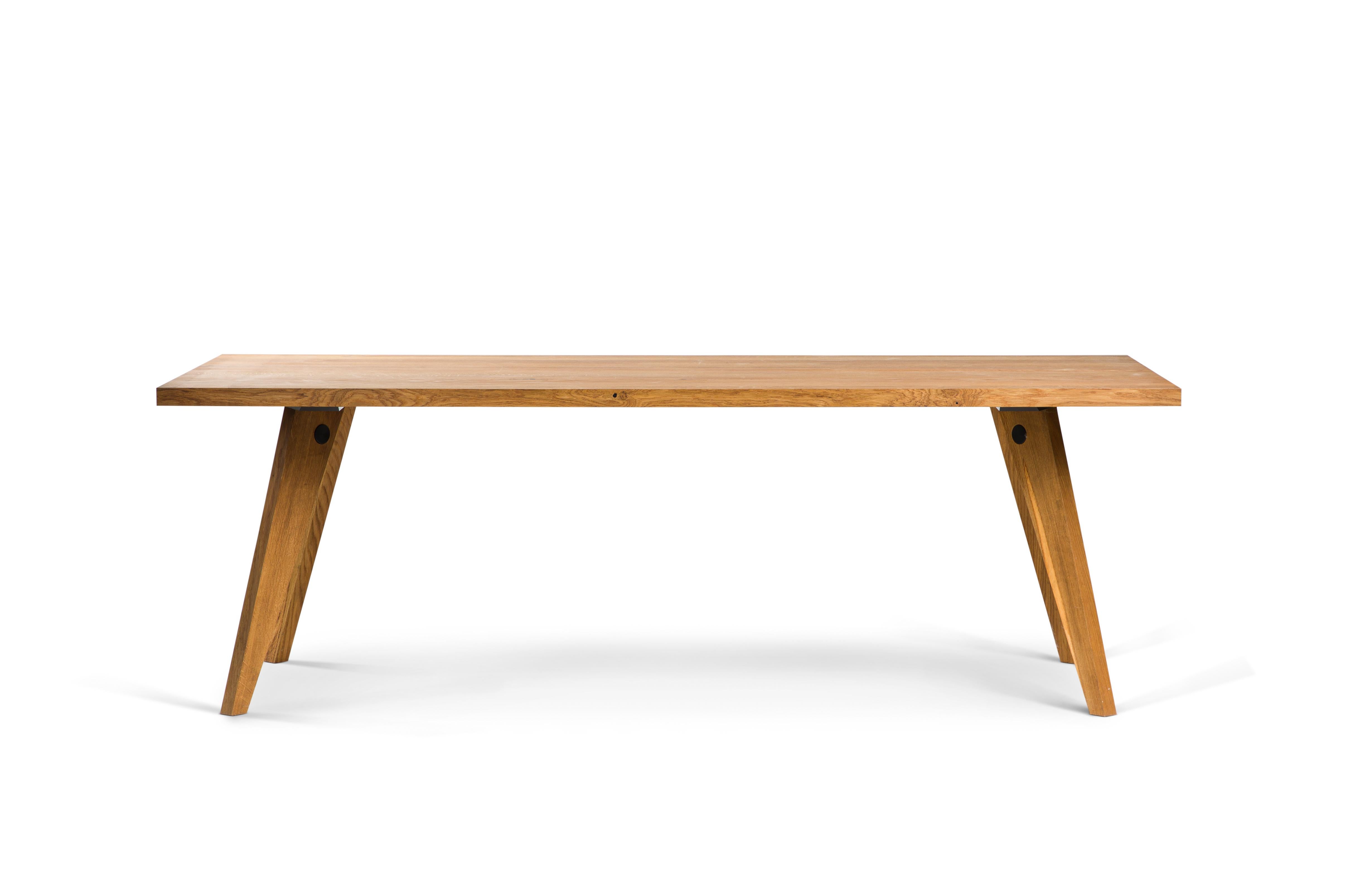 Plank table, solid oiled Danish oak. 
Heavy duty quality: two solid planks (40 mm thick) with a nice little gap in between.
Mounted on Jean Prouve-inspired base. 
The tabletop and the base can be detached from each other. Measures: 100 x 190cm.