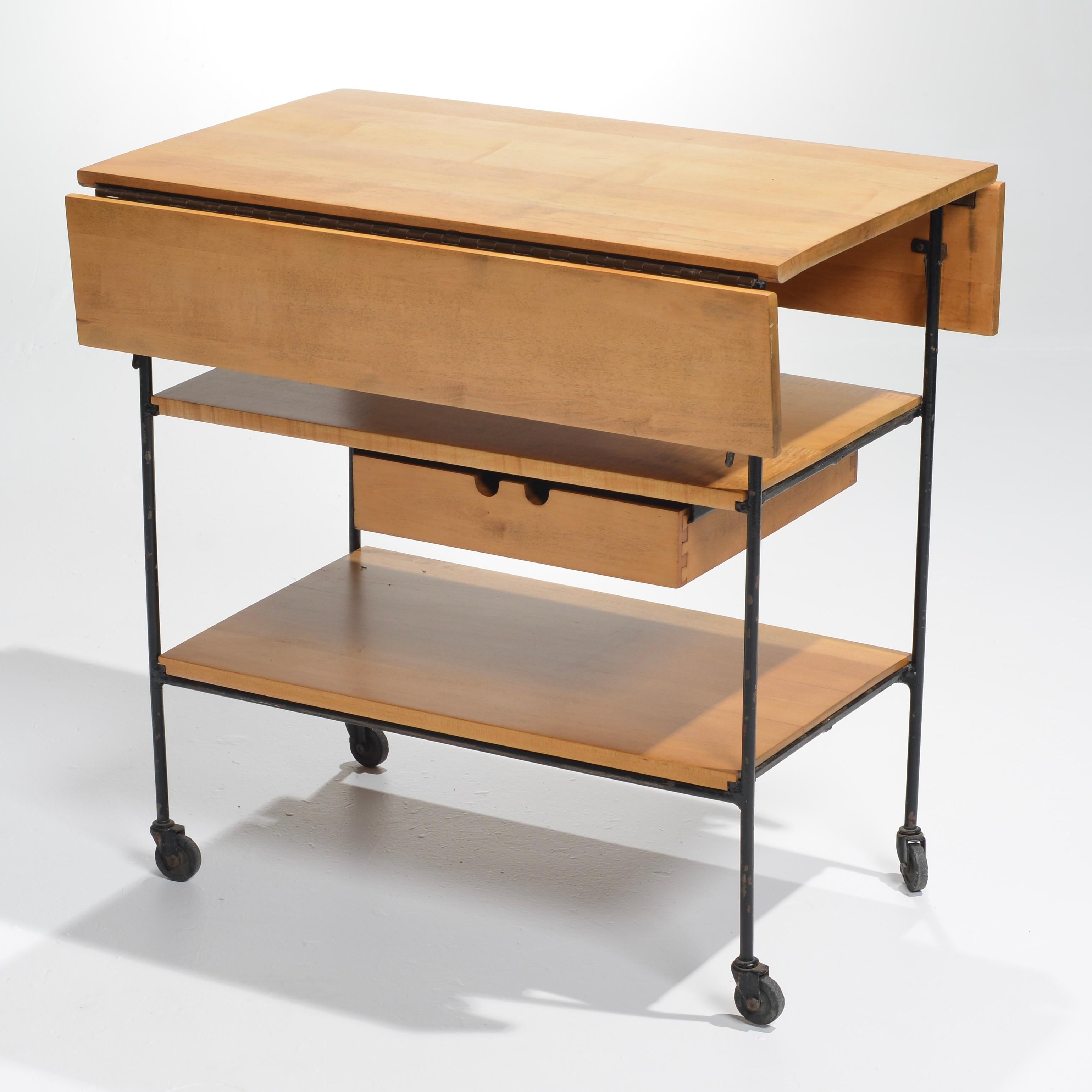 Rare Midcentury bar cart #1250 designed by Paul McCobb for planner group collection, circa 1950. Featuring one drawer and 2 fold down leaves. Original Wax mark on bottom. 
Fully Open 26