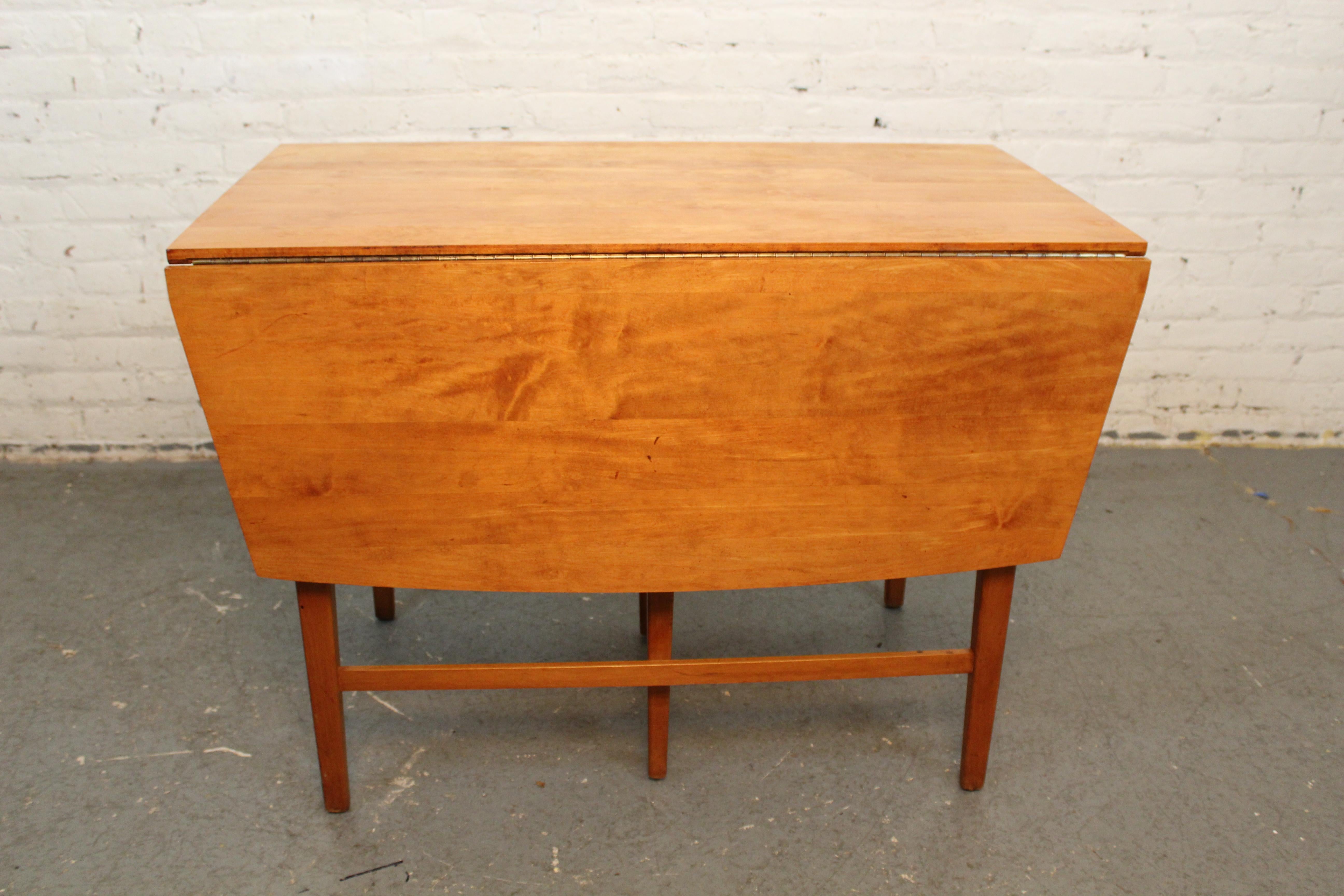 Bring home the magic of post-war New England modernism with this jaw dropping dining table designed in 1949 by Massachusetts' native Paul McCobb for manufacture by the Winchendon Furniture Company. Made for his world-renowned 