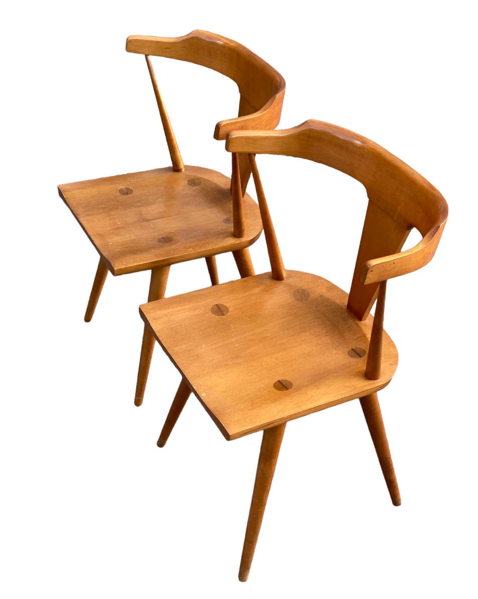 Beautiful pair of Paul McCobb Planner Group dining chairs made by Winchendon Furniture Company of Massachusetts. Executed in solid maple with exquisite original patina. In gorgeous as found condition. Solid and strong. Both chairs retain original