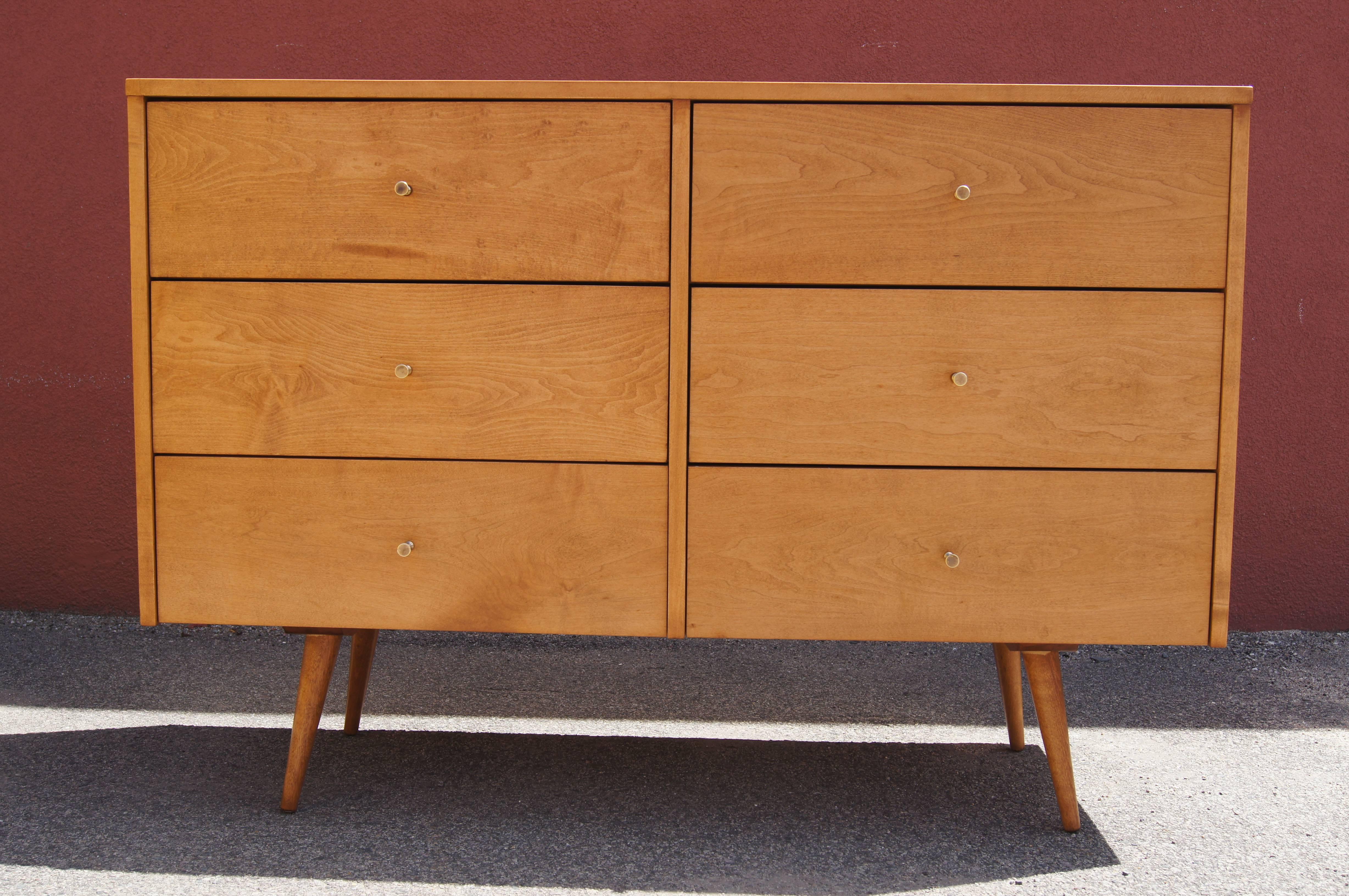 Paul McCobb designed this dresser, model 1509, as part of Winchendon's Planner Group. The maple case, set on tapered and canted legs, has two banks of three drawers, each with a conical brass pull.

A corresponding twenty-drawer dresser is also