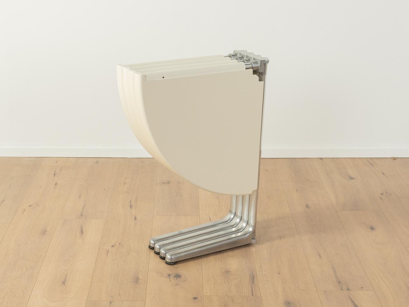 
Article Details
Award-winning folding table, model PLANO, by Giancarlo Piretti for Anonima Castelli from 1971. High-quality frame made of stainless steel and cast aluminium with a four-piece table top made of fiberglass in off white. The table can