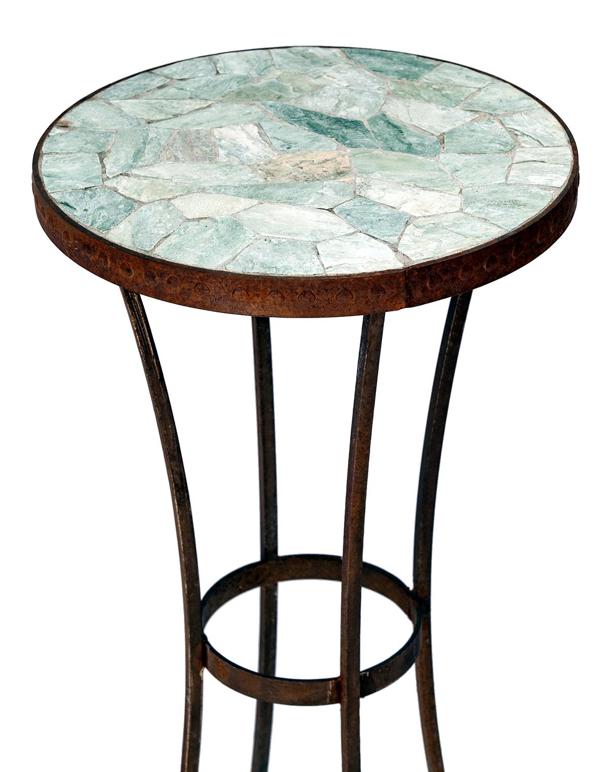 This simple iron plant stand features a mosaic slate top securely set within an iron frame, ensuring the piece is robust and durable.