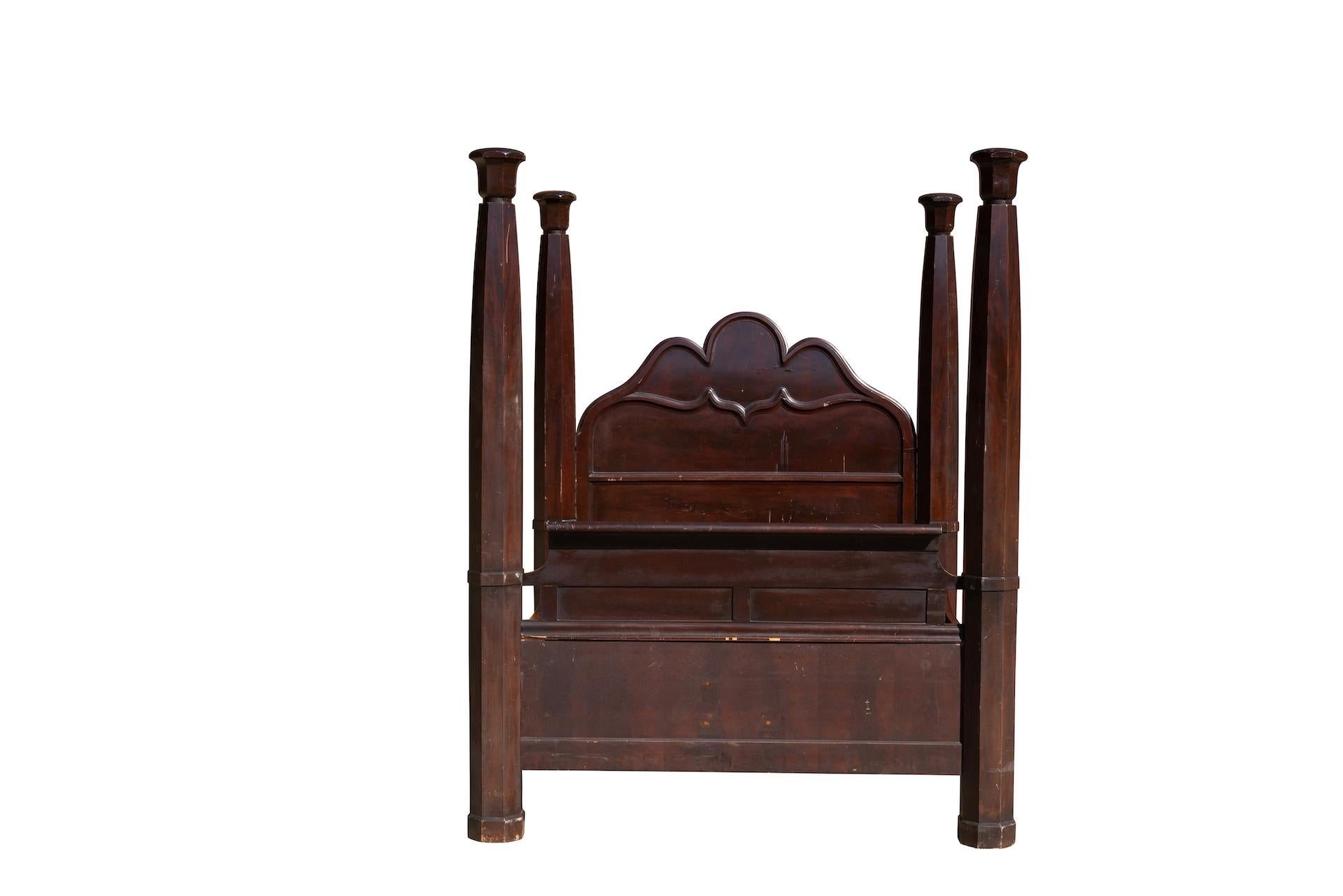 Plantation four poster bed of solid mahogany, queen size. Circa 1850s. Substantial and extremely heavy, the solid mahogany of the four posters was harvested from primordial forests and shipped from England to the United States. The bed design
