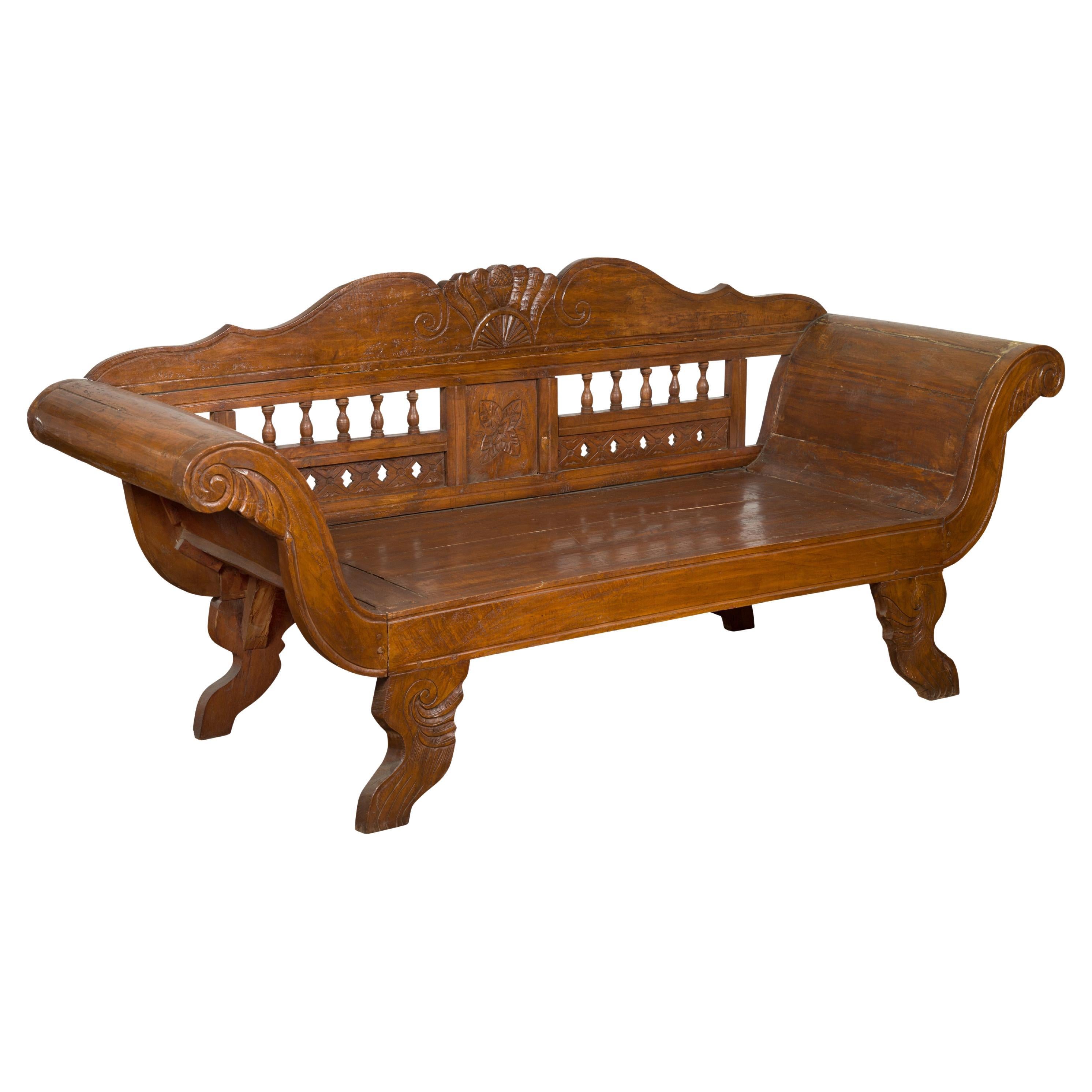 Javanese Teak Settee with Carved Décor and Out-Scrolling Arms For Sale