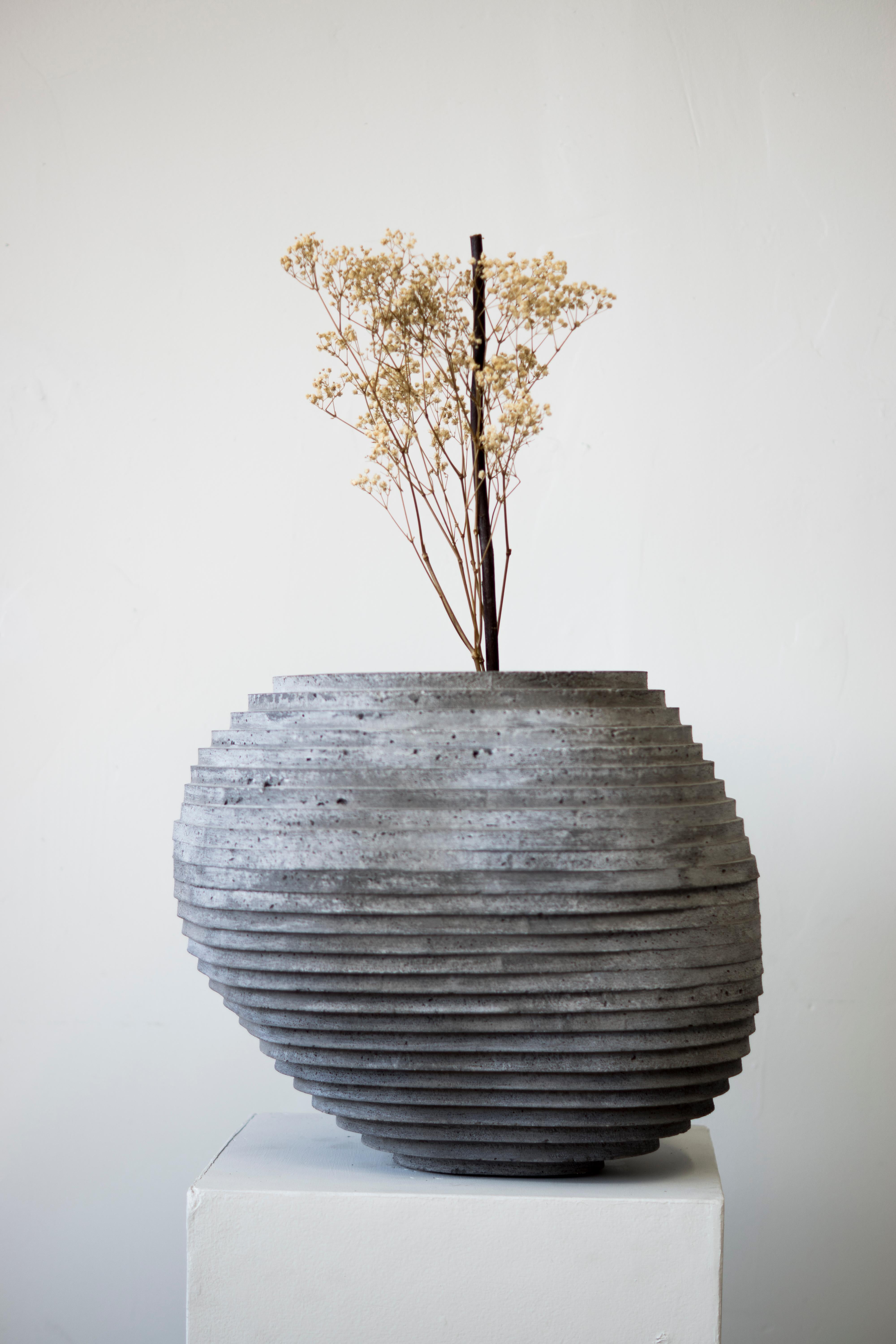 Large hand-cast planter for indoor and outdoor use. Drainage holes can be added upon request.

At the intersection of art, craft, and design, Concrete Poetics' debut collection of hand-cast cement sculptural furniture and accessories streamlines
