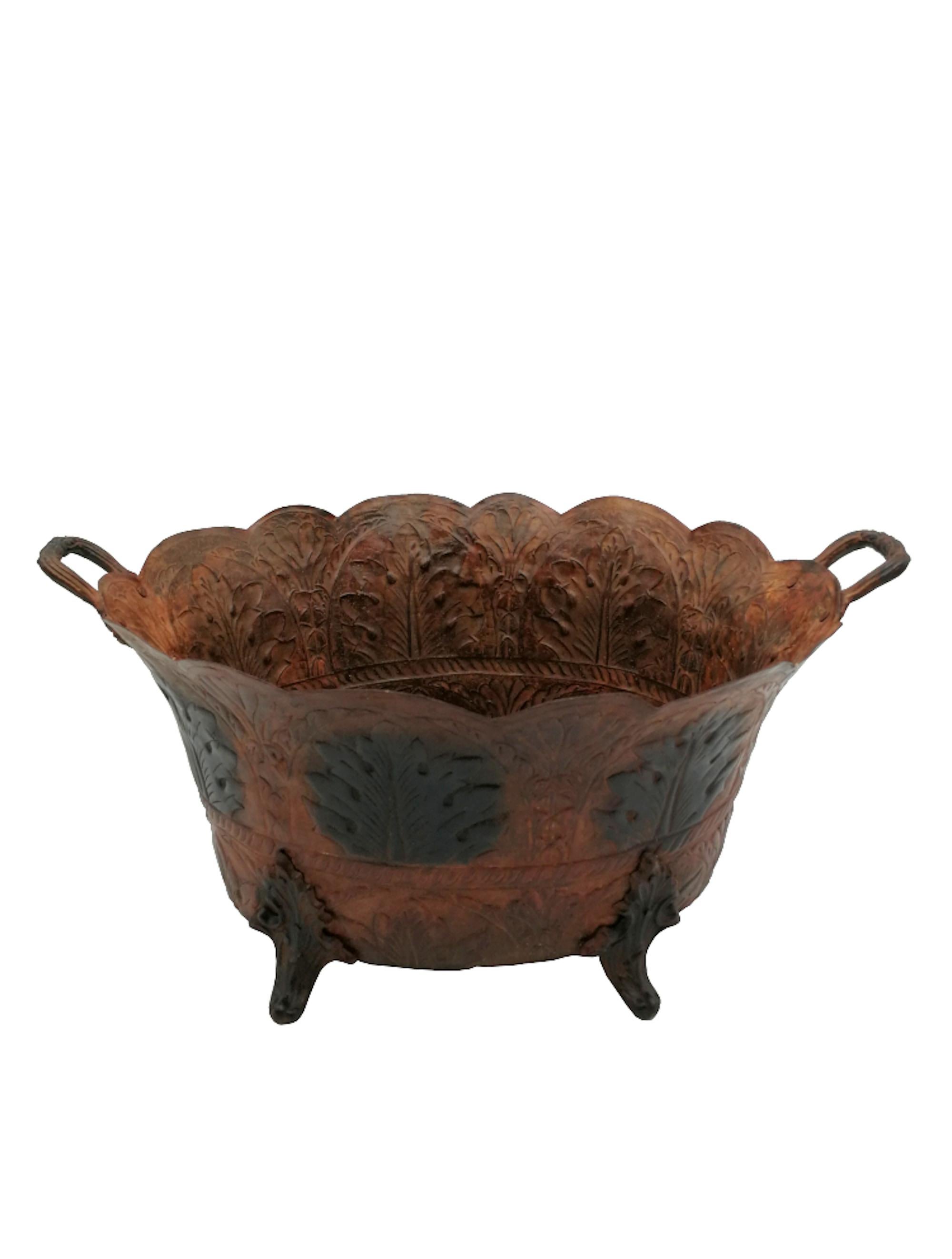 Art Nouveau brown painted tole planter with hand embossed acanthus leaves decoration standing
on 4 feet shaped as acanthus leaves and 2 handles with fruit decoration. The tole is painted in 2
different tones of brown. High quality embossing with