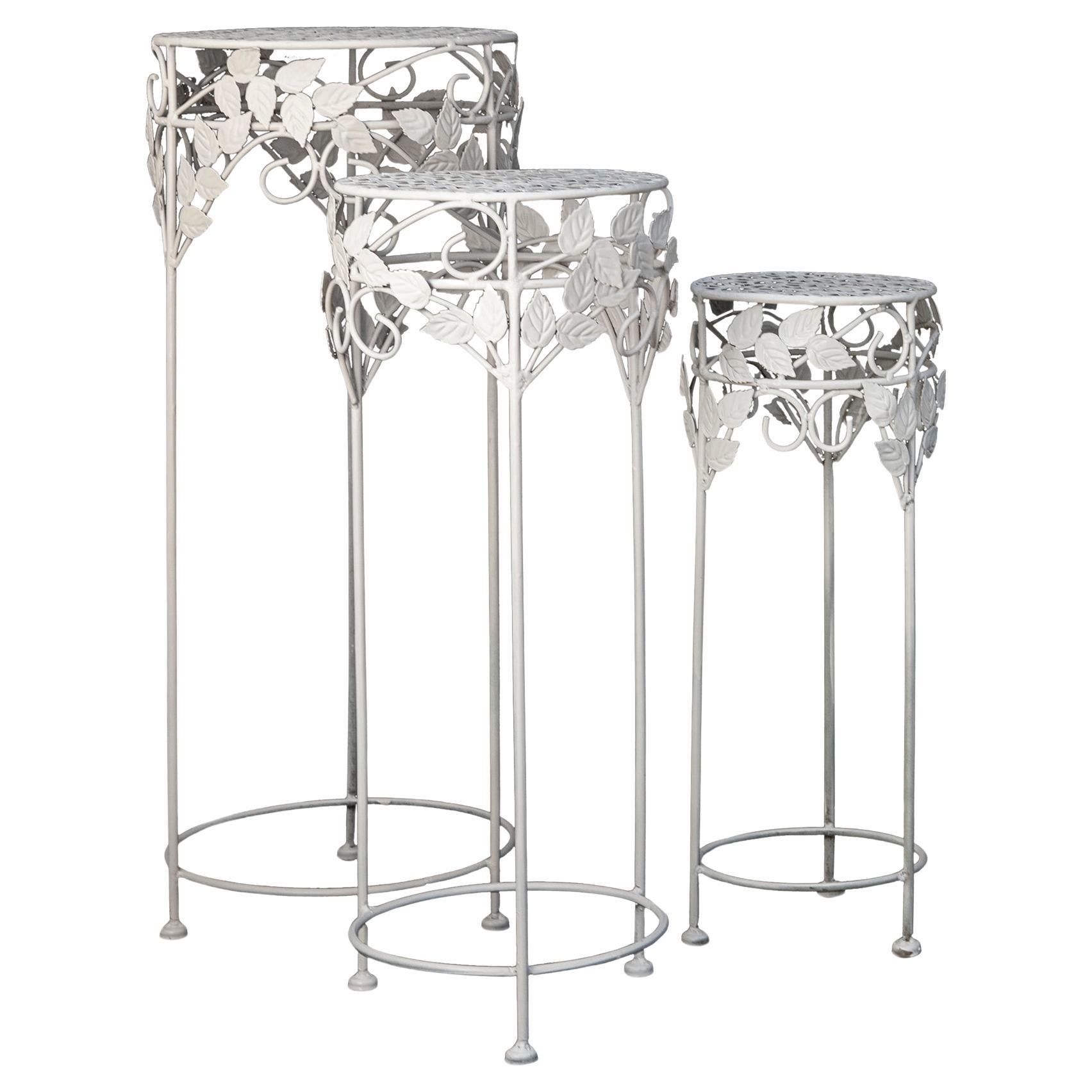 Charming set of plant stand made of iron & sheet metal.
Clusters of leaves decorate the stands. The tops of each stand have an open gridwork pattern. The stand can fit under the largest one perfectly.
They are sturdy yet delicate. The thin legs have