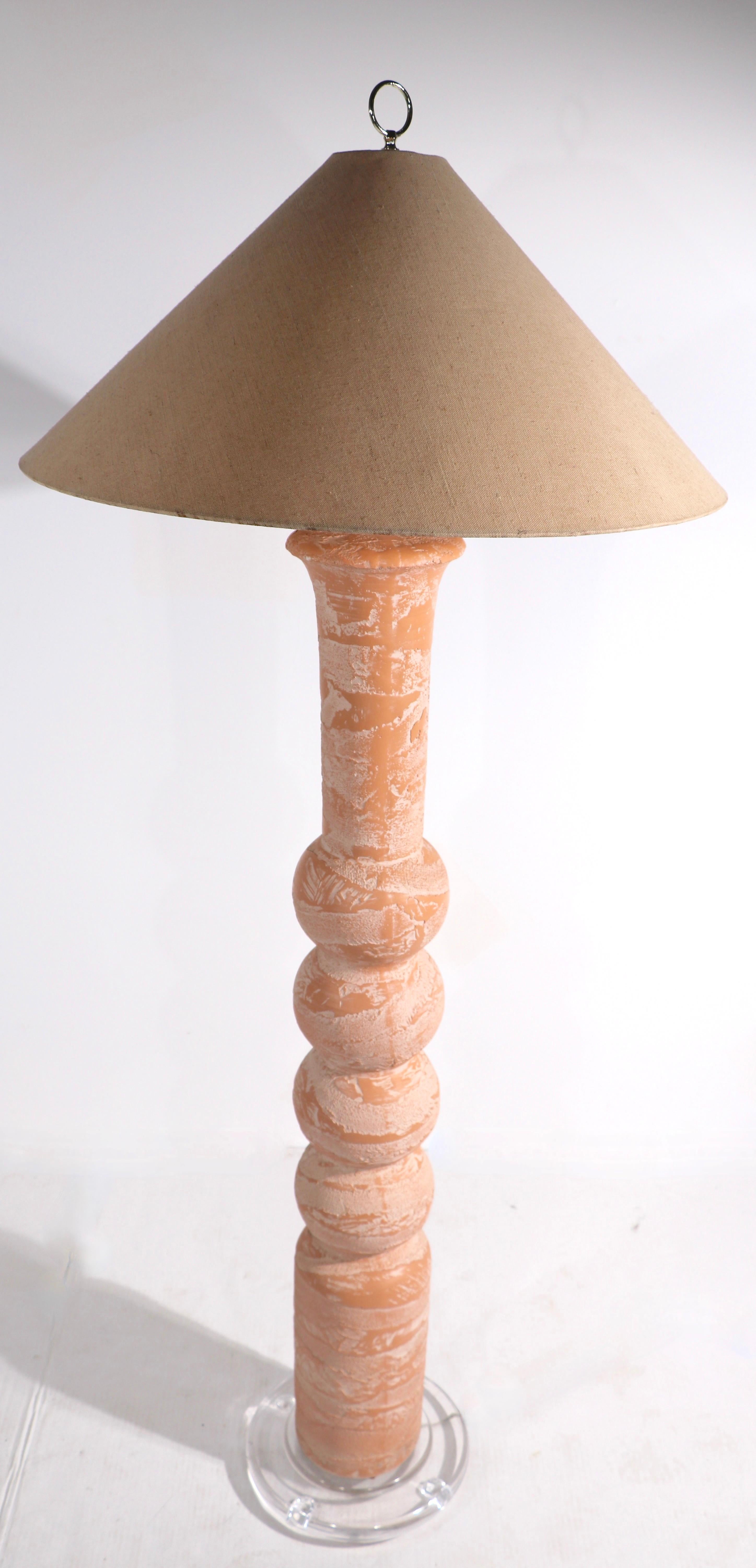 Impressive 1980's plaster floor lamp with thick lucite disk form base. The lamp has a textured peach colored surface of cast plaster, the shade is included, but shows some imperfections. 
 Shade dimensions 25.5 Diameter x 11 height inches. Base 12