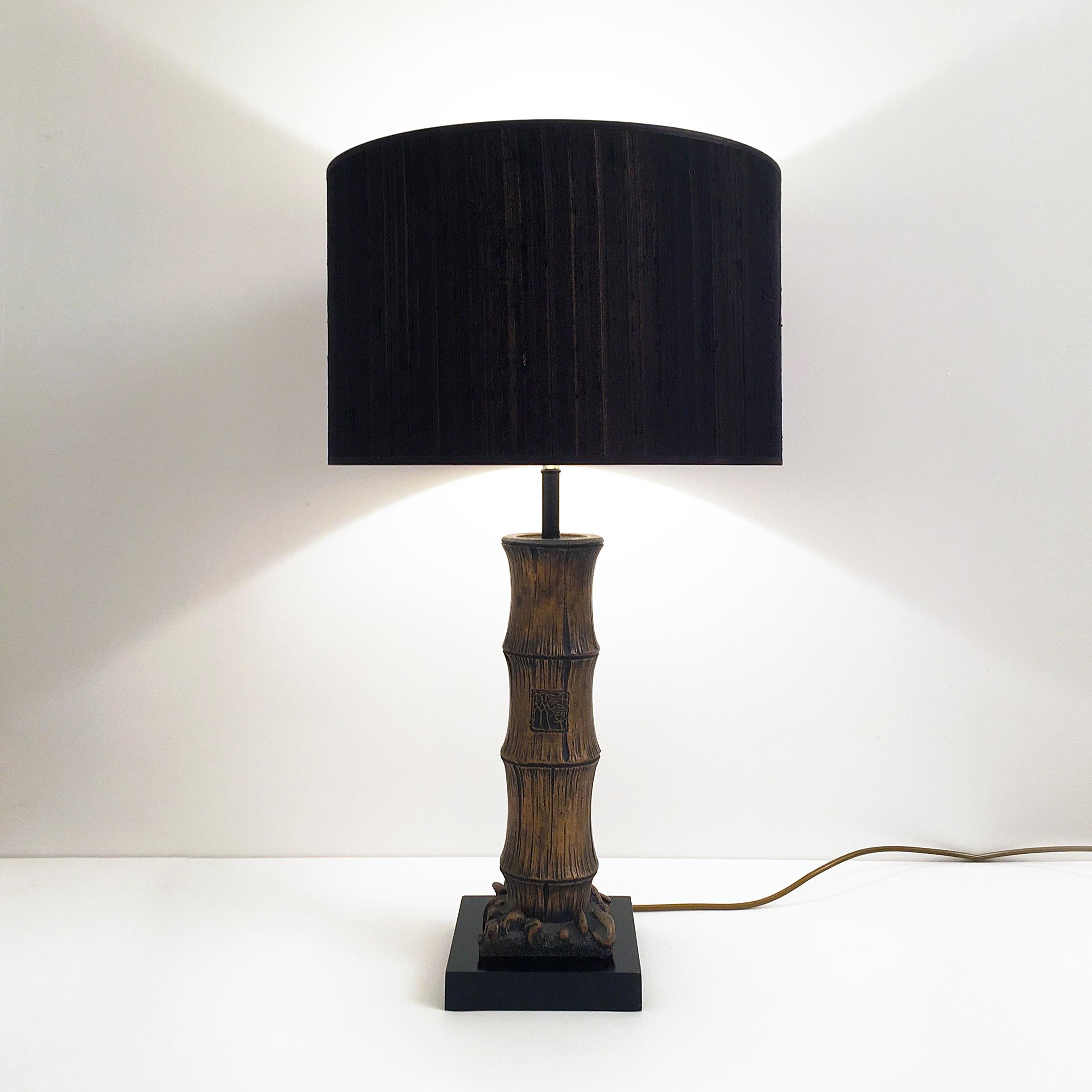 Impressive wood carved faux-bamboo table lamp, with Chinese-stamped lettering on an ebonized base (lamp shade is for display purposes only). 

CREATOR: Unknown 

PLACE OF ORIGIN: France

DATE OF MANUFACTURE: c. 1970's

PERIOD: 1970 - 1979

MATERIALS