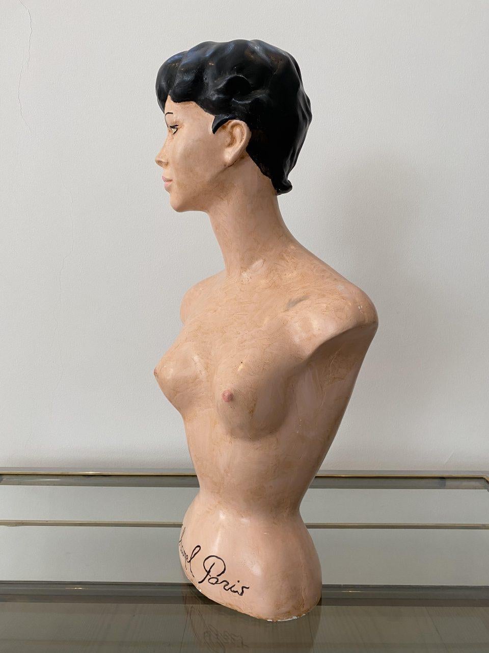 Seductive and naughty bust / mannequin of a young woman. Made of painted plaster and is made as a sensual and attractive femme fatale with a nice and lush bosom.

The bust was originally produced for the world-renowned French fashion house Chanel