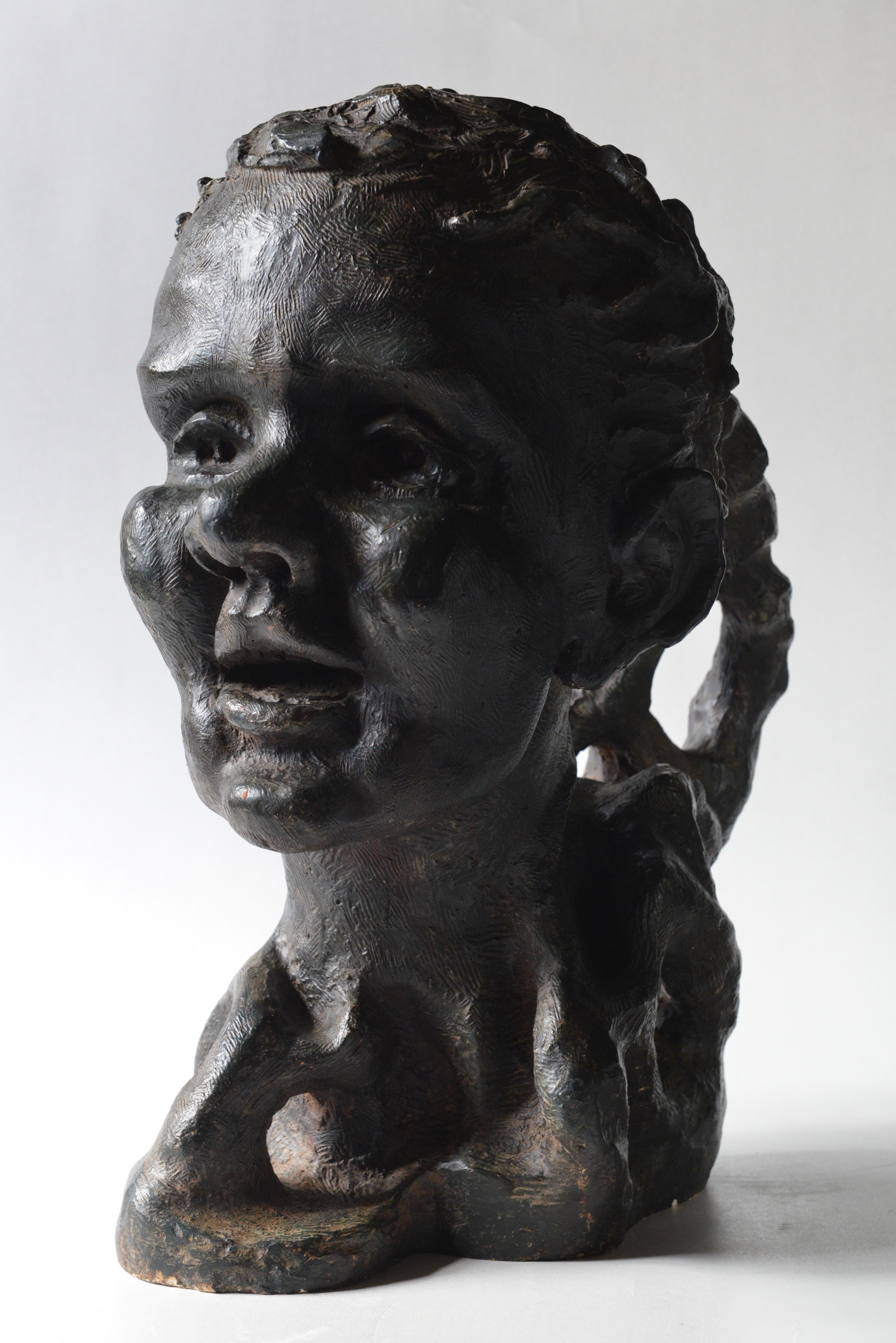 A bronze patinated plaster of a woman, her head covered with branches. 
The Greek mythology Philemon and Baucis story. Baucis saw Philemon begin to leaf out and Philemon saw Baucis leaf out too. Their faces remained at the top of the growing trees.