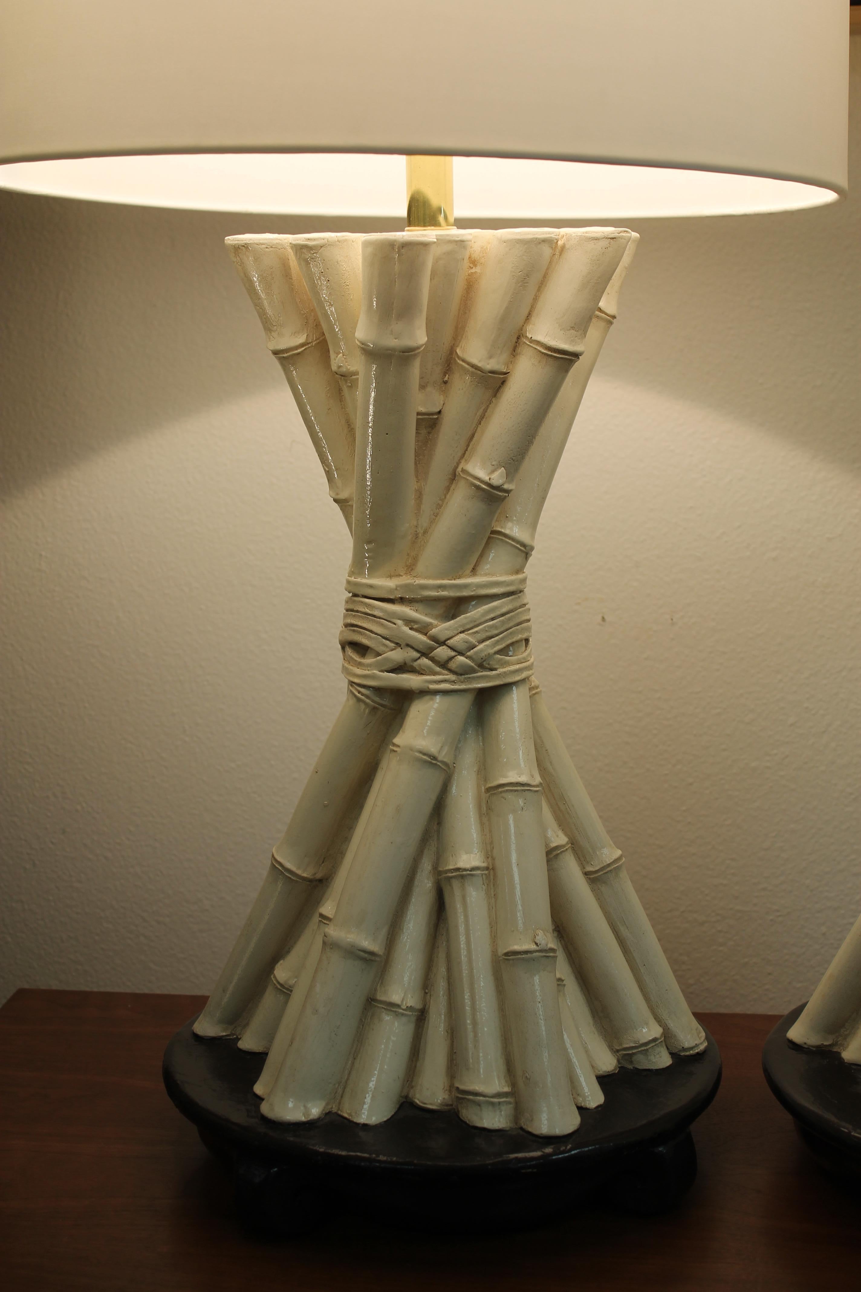 Pair of plaster lamps by Lighthouse and dated 1977. Pattern of tied bundle of bamboo. Plaster portions of lamps are 20.25” high with a 3” brass neck. Total height from base to the bottom of socket is 23.5
