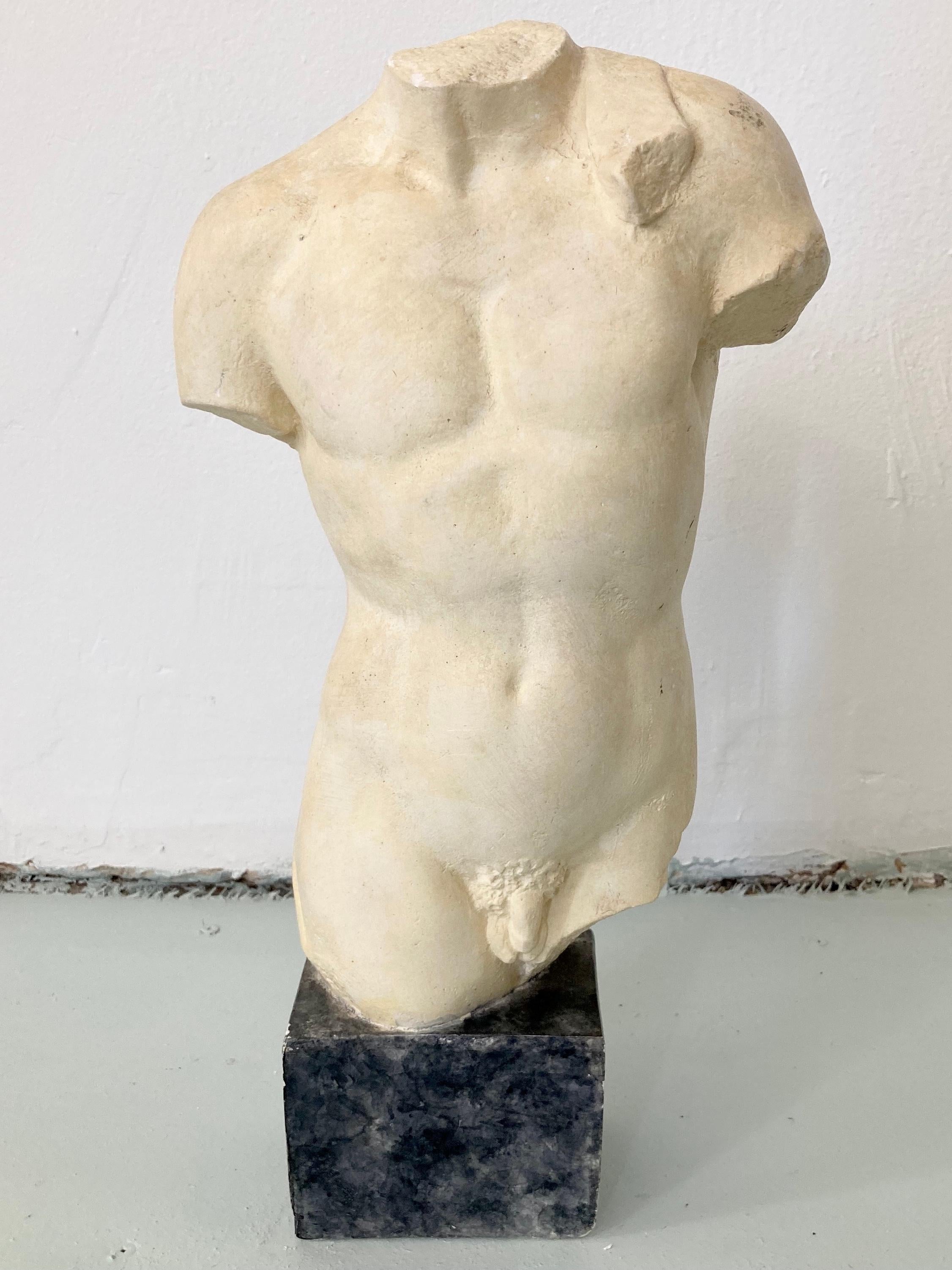 Classically sculpture of a male body on a base. Great addition to your architectural interiors. Plaster form with original finish dome wear for its age that adds to its character.