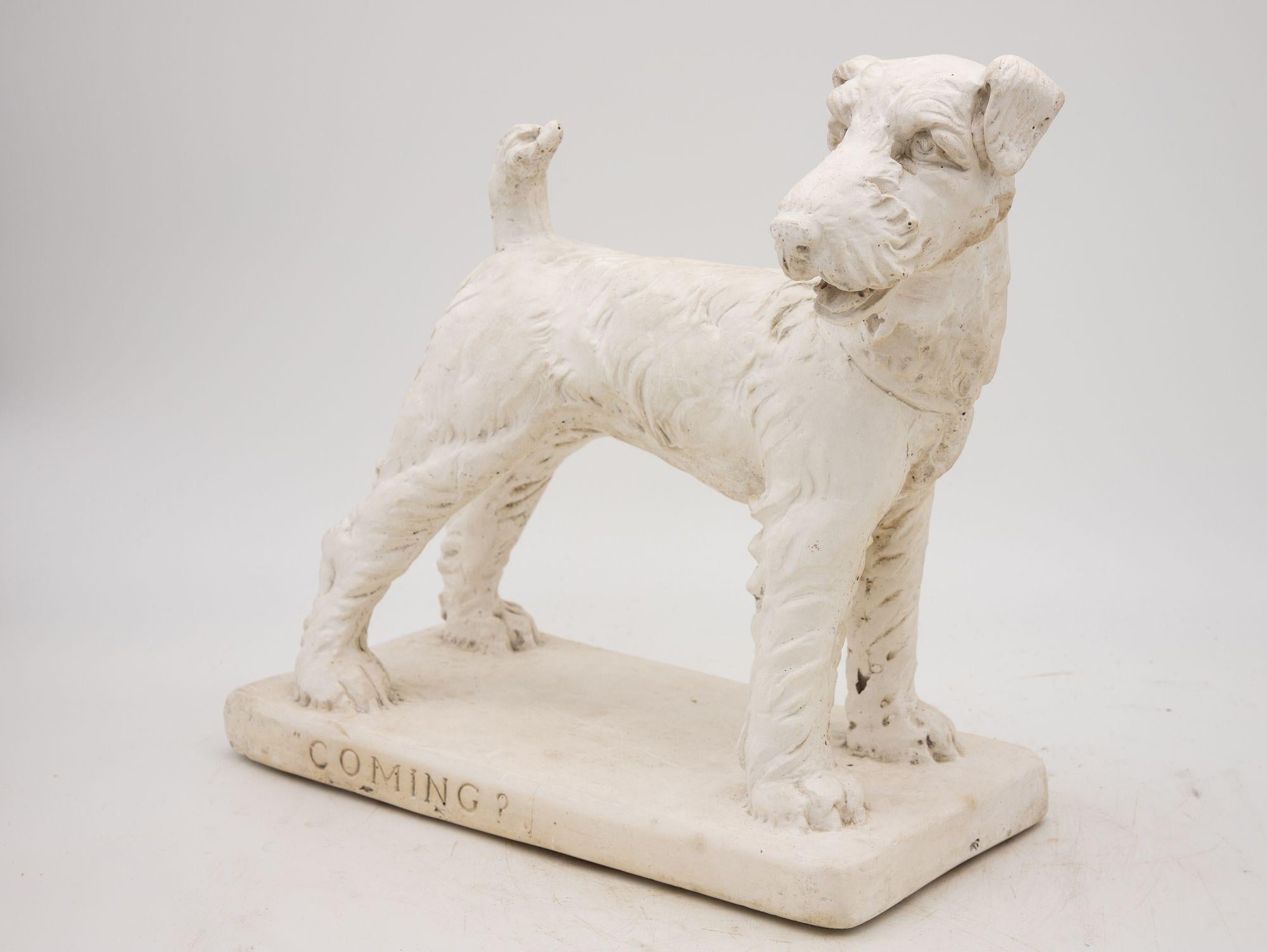 A delightful relic of the 20th century, this plaster terrier dog model exudes timeless charm. With intricate attention to detail, the terrier's lifelike features are masterfully captured, showcasing the artistry of its era. Perched upon a base that
