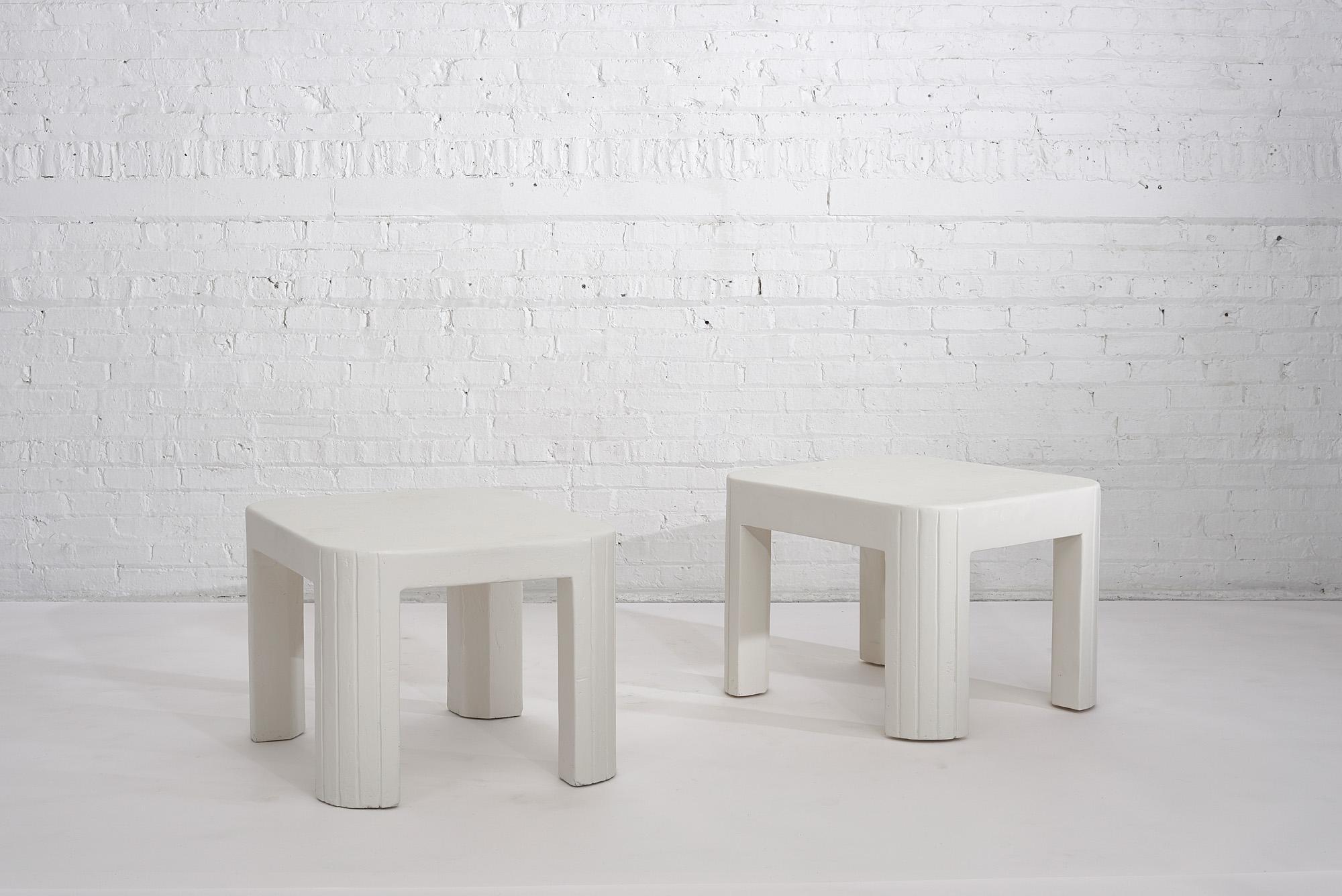 Pair of plaster postmodern end tables, circa 1970s. Great design with rounded edges, lined detailing on the legs.