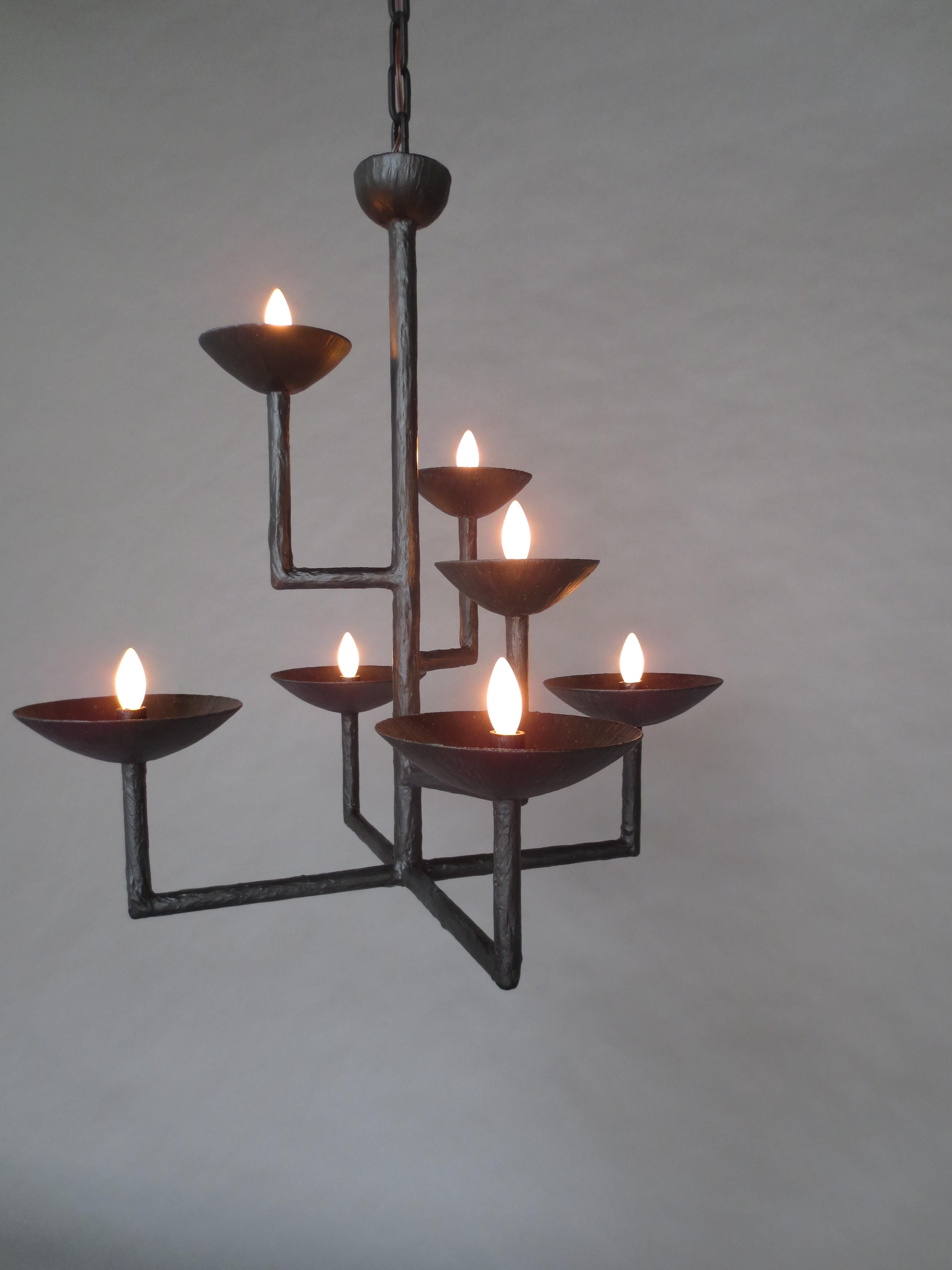 Plaster 7 Cup Bronze Finish Chandelier
Seven cup and seven light square chandelier with L-shaped extended arms. Plaster and steel multi armed chandelier with a bronze enamel finish. May include ball, ceiling cap along with matching chain. These