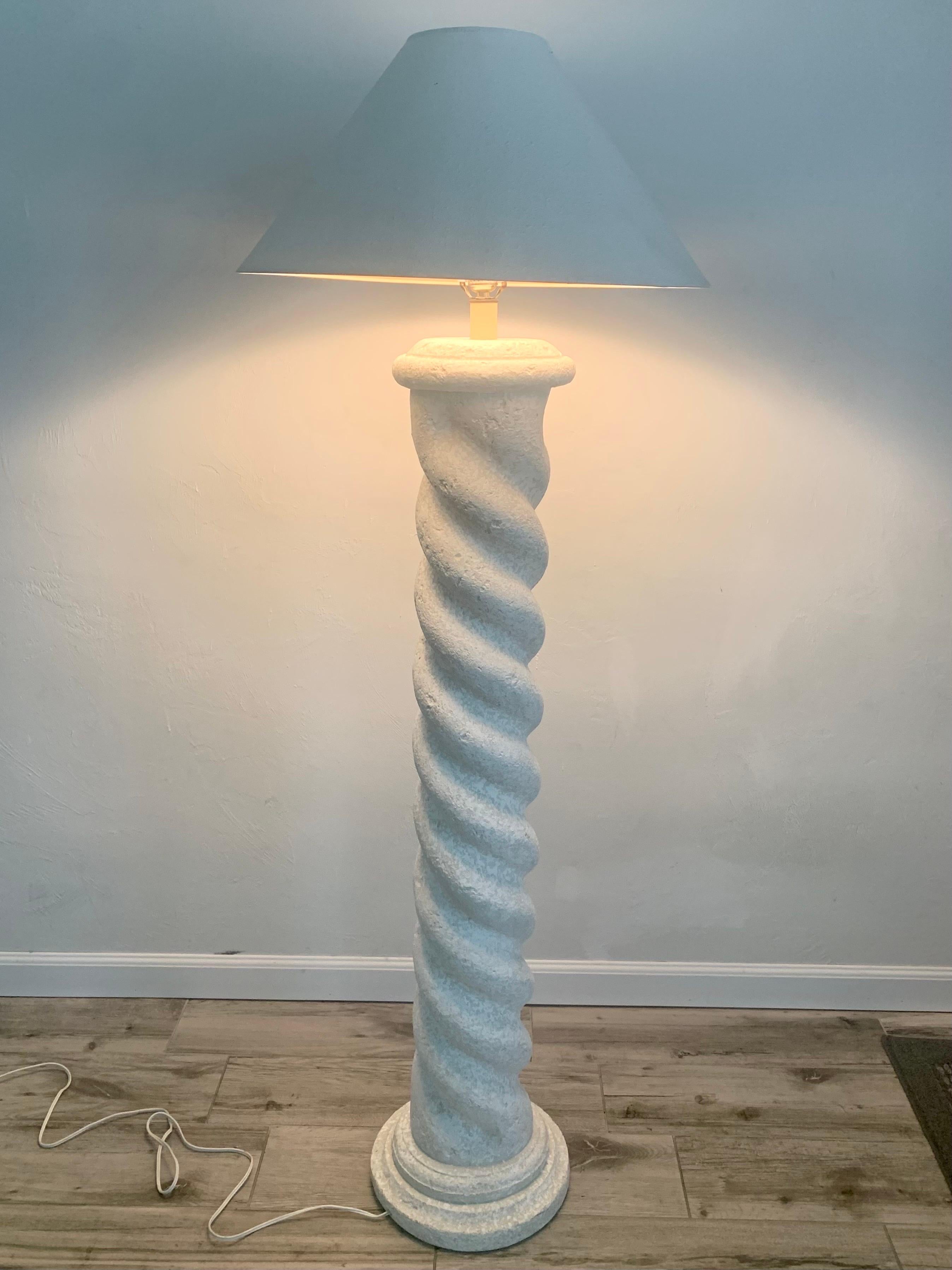 Sculptural plaster floor lamp in the style of Michael Taylor. Sporting a spiral column design with a round base. Textured plaster offered and organic elegance reminiscent of white washed stone or unfilled travertine. 

Lamp is 59” tall with a base