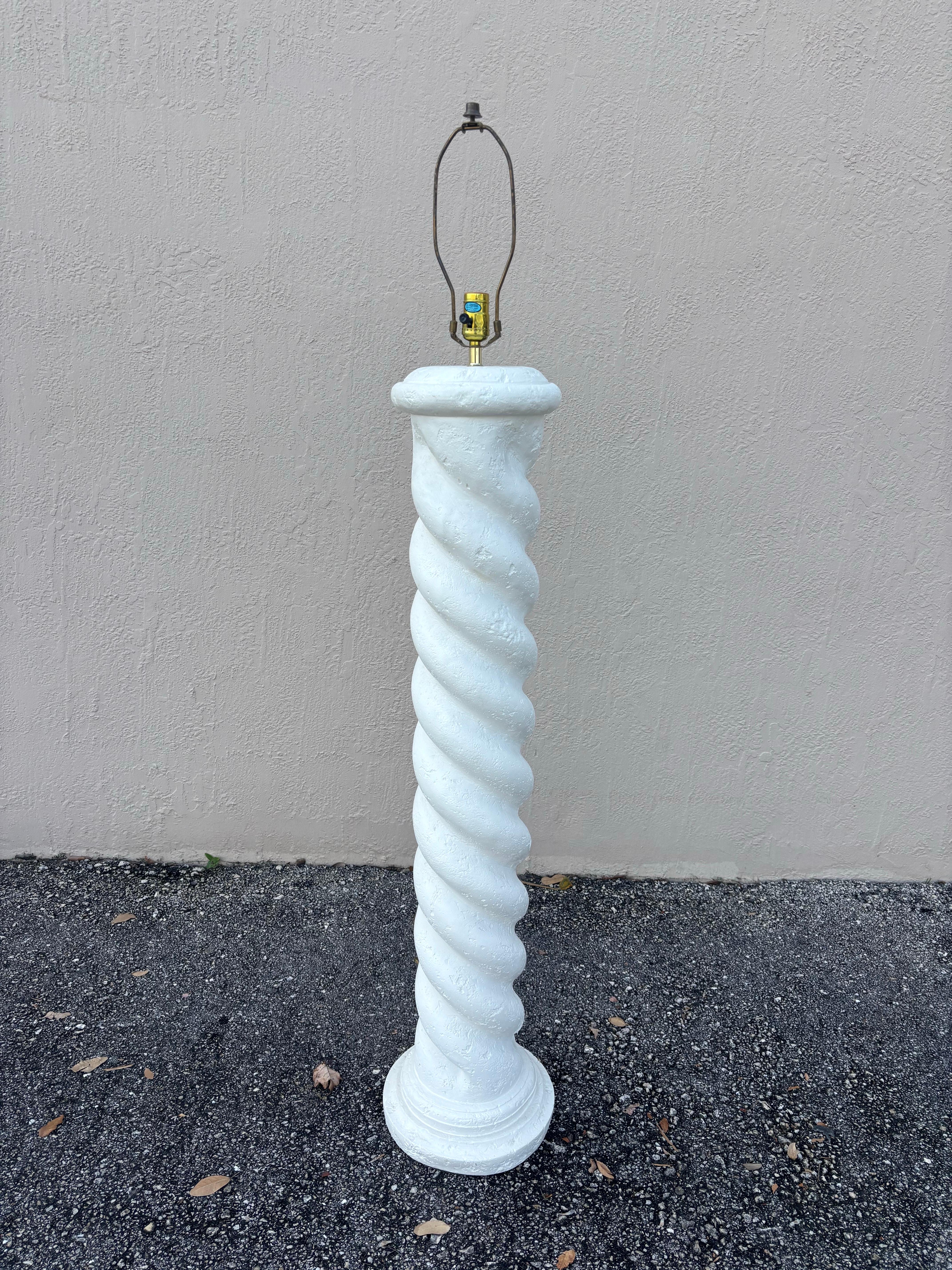 Sculptural plaster floor lamp in the style of Michael Taylor. Sporting a spiral column design with a round base. Textured plaster offers an organic elegance reminiscent of a white washed stone or unfilled travertine. 

Wired to work with a 3 way