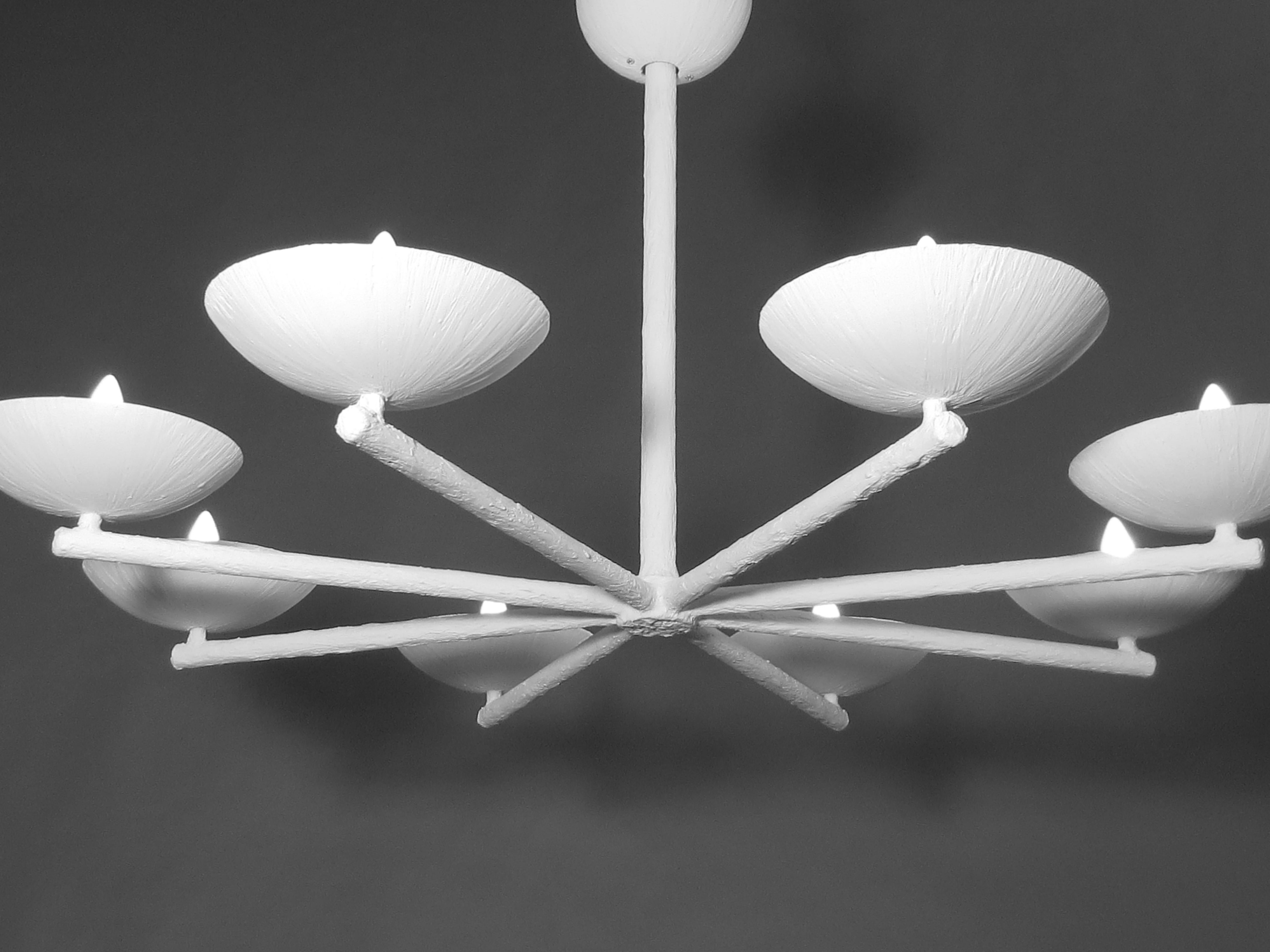 Eight spoke, eight-light and eight cup chandelier by Apsara Interiors. Up light. Can be ceiling fixture or chandelier length. Plaster and steel multi armed chandelier with a white enamel finish. May include ball, ceiling cap along with matching