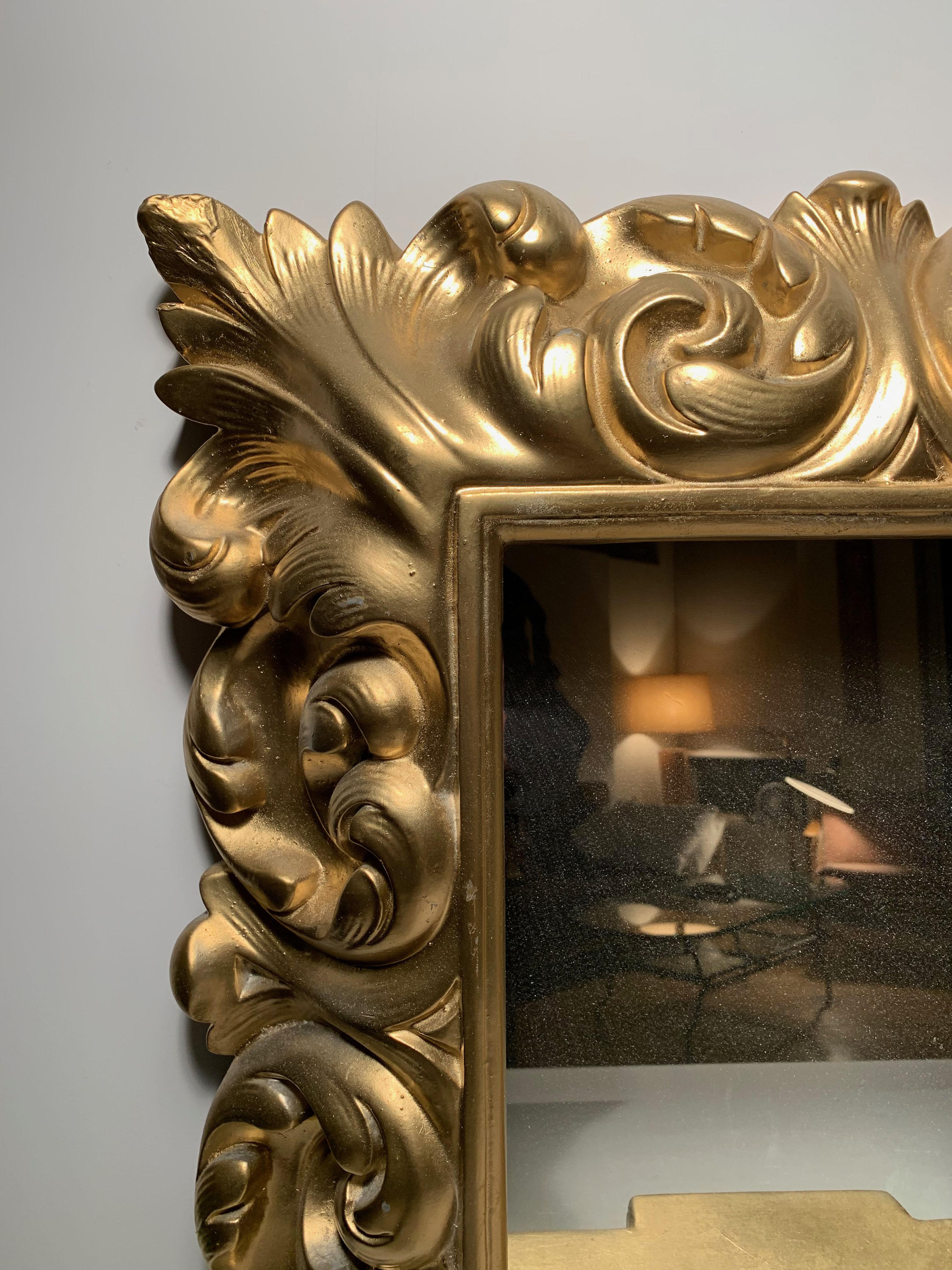 Plaster wall mirror Hollywood Regency. Originally a white plaster. This one was recently painted gold. Can easily be painted white over the gold if desired. A picture is included showing how these frames look in white. In the manner of Serge Roche