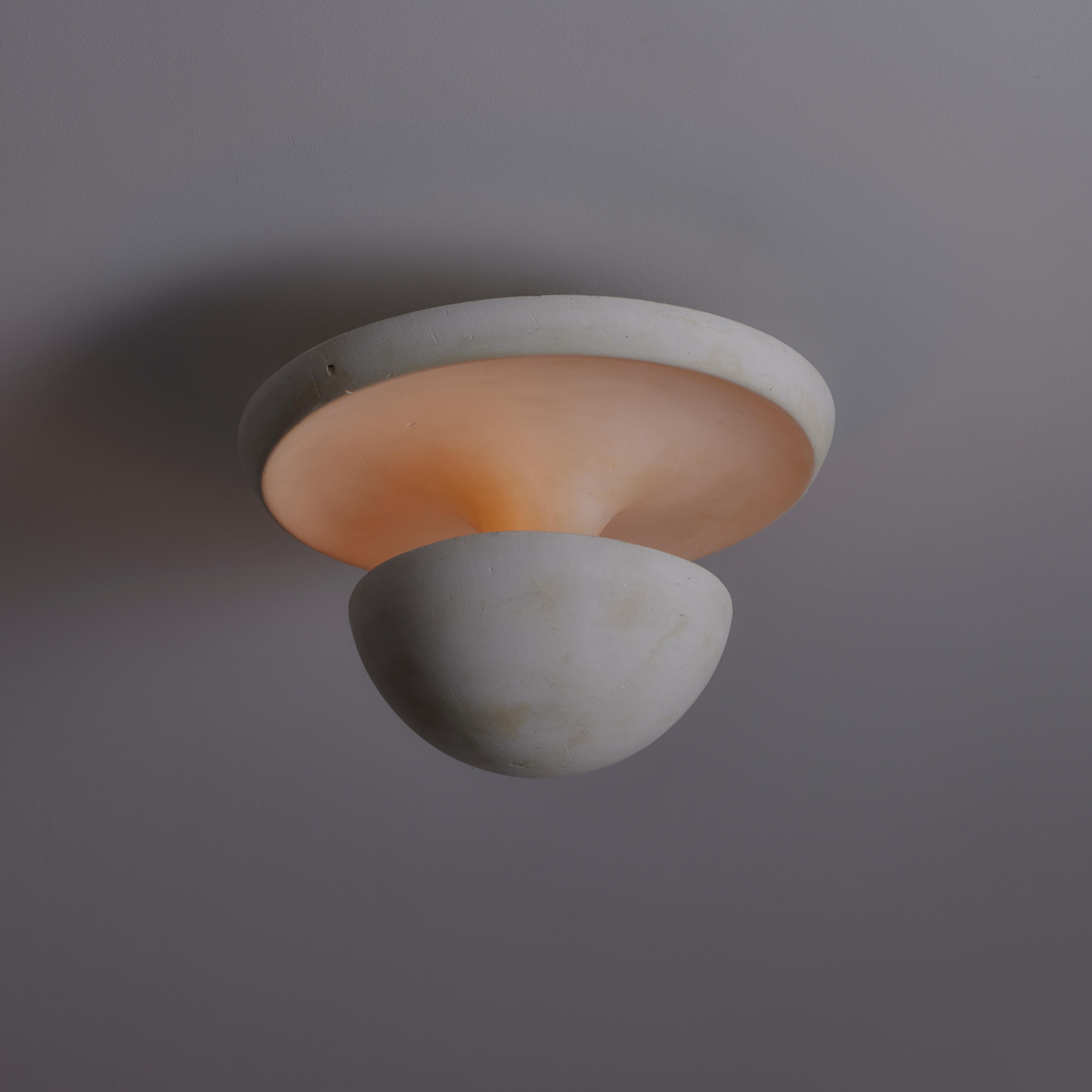 Plastered French Flush Mount. Designed and manufactured in France, circa the 1940s. An all plaster flush mount with a fluted relief and bottom bowl allowing for an eclipsed illumination reflecting towards the center and out onto the fluted upper