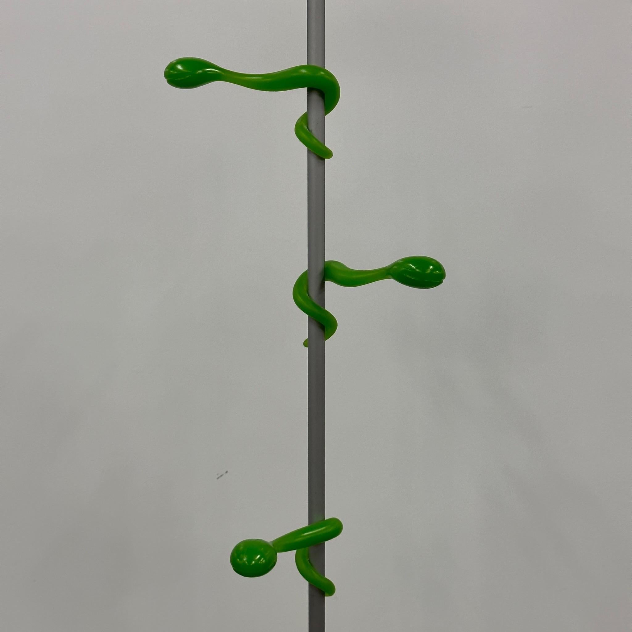 c. 1990s. Fun plastic coat rack made in Germany. Each hanger is moveable on the pole. Base is good for additional storage. 