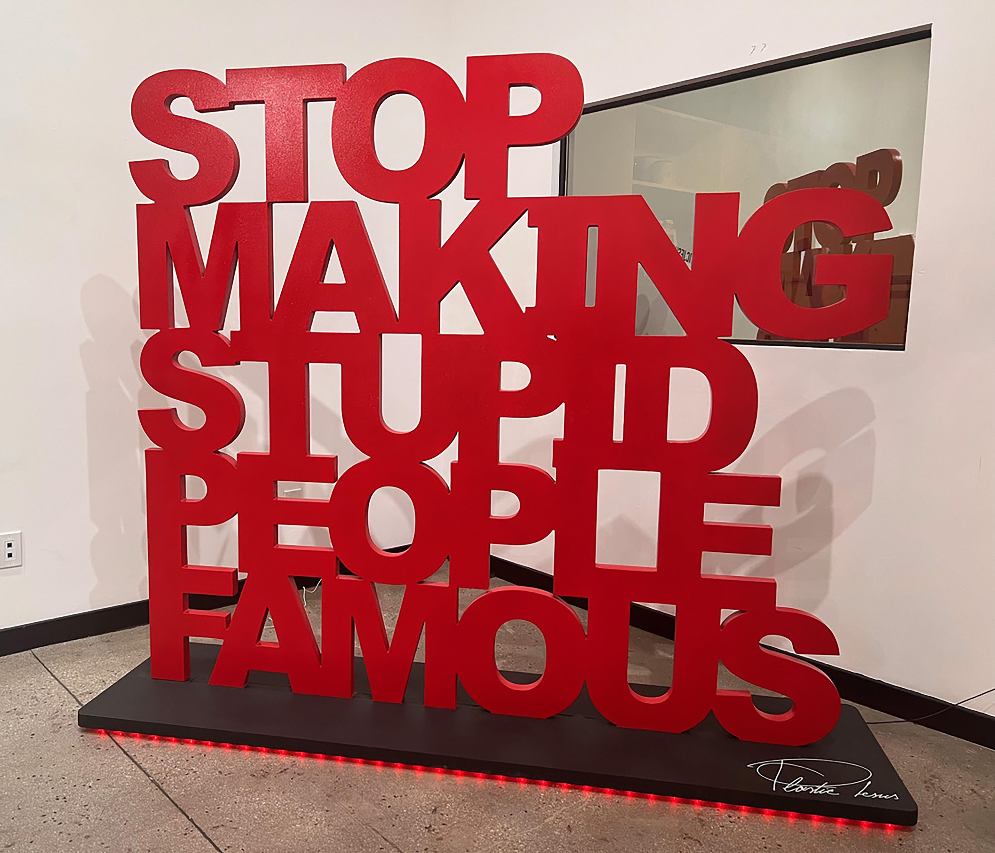 « Stop Making Stupid People Famous » - Grand bois avec insallation en polyuréthane - Sculpture de Plastic Jesus