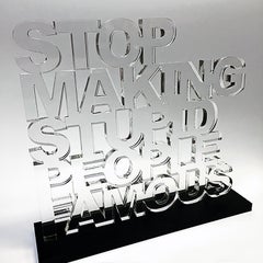 "Stop Making Stupid People Famous" - Clear Acrylic Sculpture with Black Acrylic