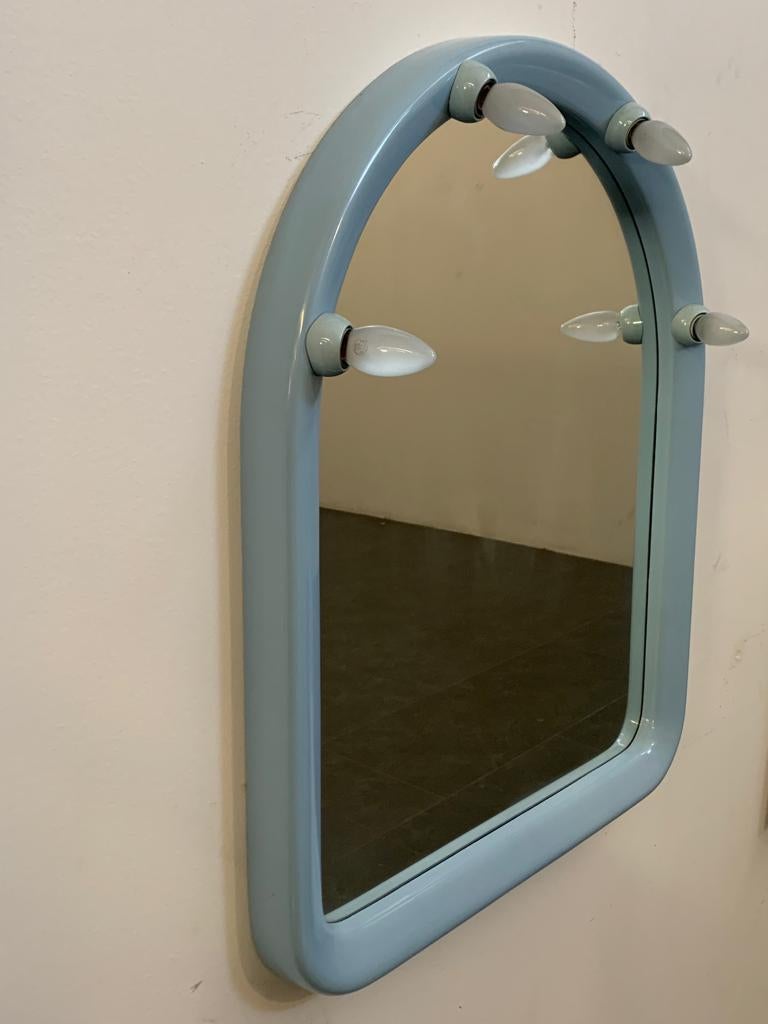 High-quality plastic mirror of generous thickness, the shape is niche-shaped and at the top it has plastic fittings for housing four light bulbs. Manufactured by Carrara & Matta, I have official proof of authenticity as period catalogues, design
