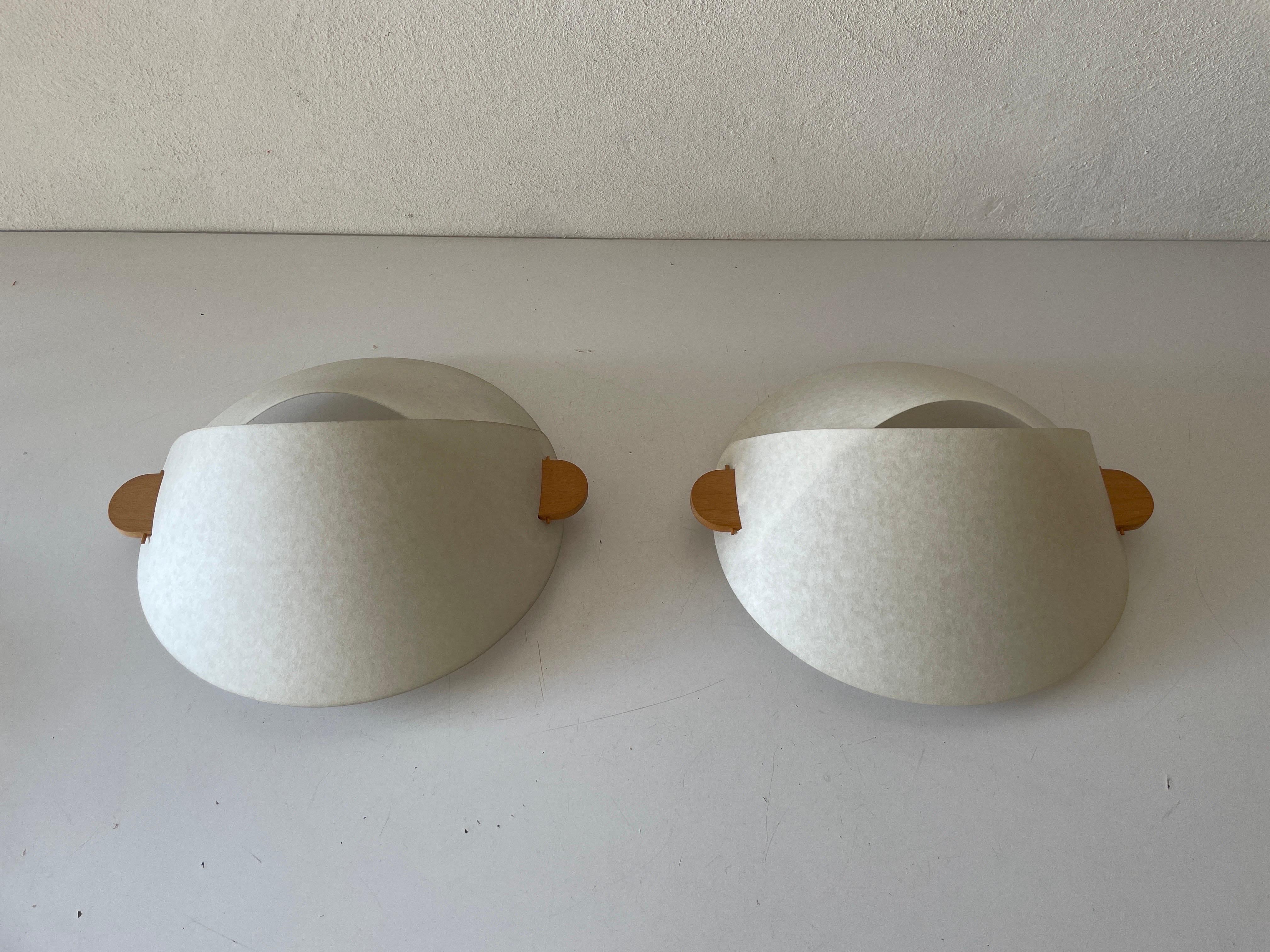 Plastic Paper and Wood Pair of Sconces or Ceiling Lamps by Domus, 1980s, Italy

Minimalist and rare design. 

Lampshade is in good condition and clean. 
This lamp works with 2x E27 light bulbs. 
Max 100W Wired and suitable to use with 220V and 110V