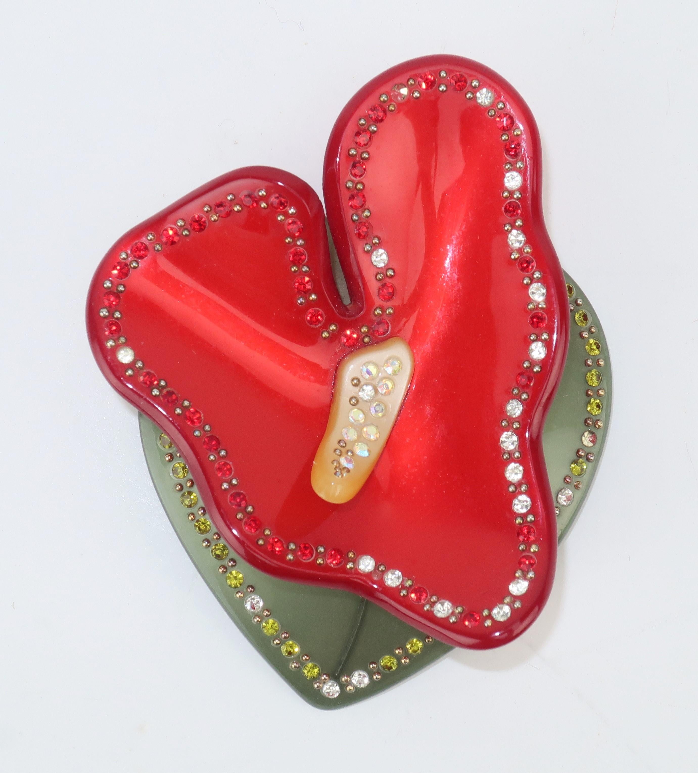 Retro red, butter yellow and moss green plastic tropical flower brooch embellished with red, green and crystal rhinestones mixed with tiny studs for just the right amount of bling.  Outfitted with straight pin and safety catch.  Perfect for a Spring