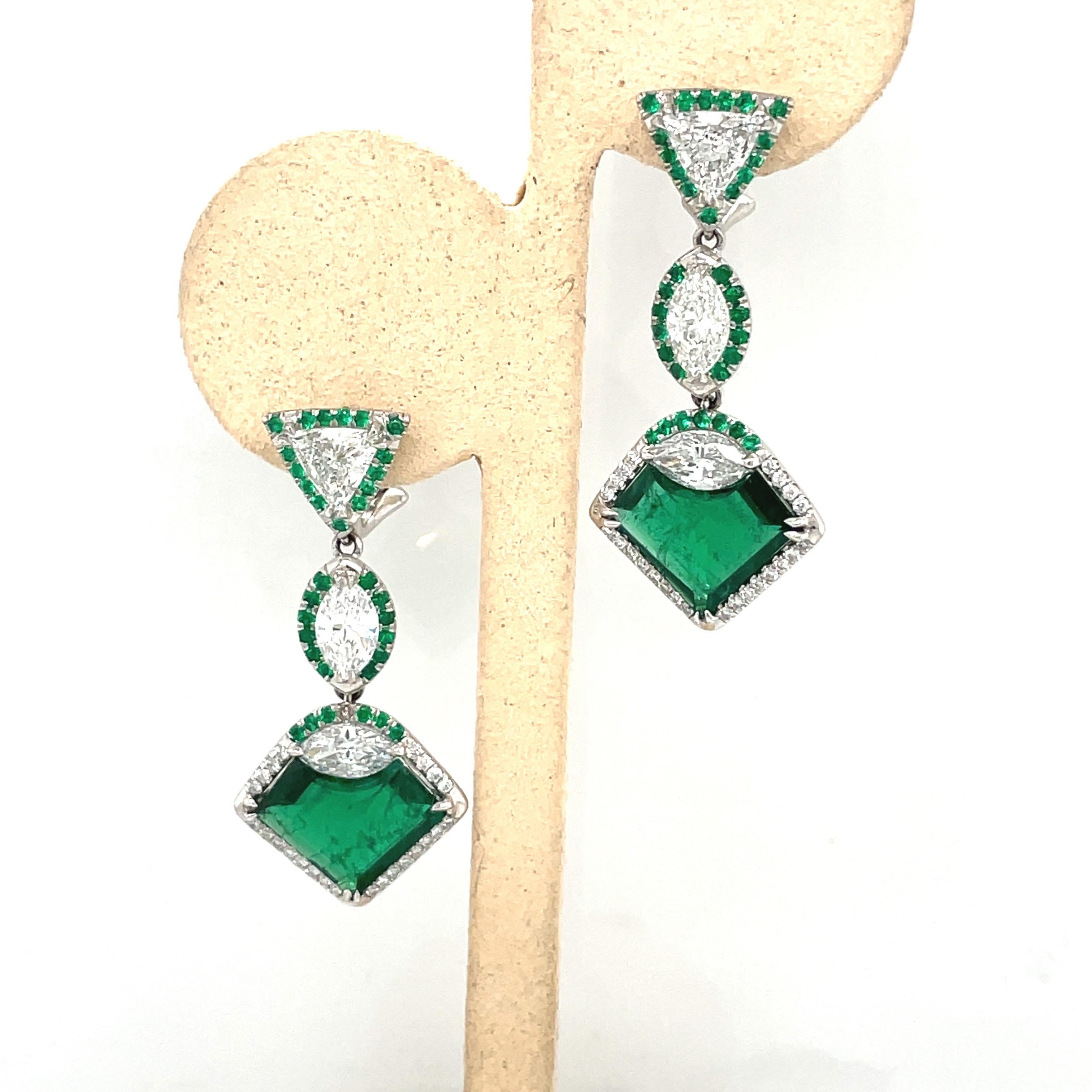 Absolutely breathtaking art deco inspired emerald and diamond earrings. Designed with 2 gem quality heart shaped emeralds weighing 6.74 carats. There are 2 trillion diamonds of F color VS clarity weighing 1.47 carats, and 4 marquise diamonds F color