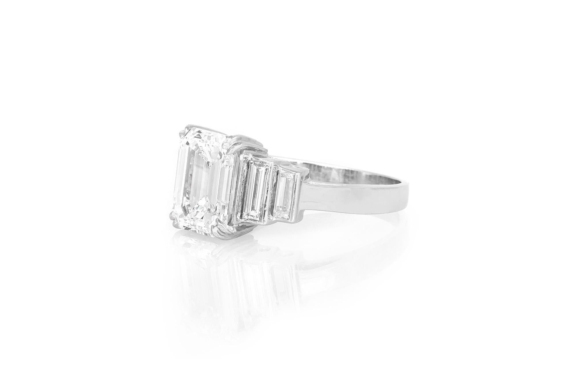 Finely crafted in platinum with a GIA certified 3.01 carat Emerald cut center diamond.
G color, VS1 clarity.
The ring features two Baguette on each side weighing approximately a total of 1.30 carats.
Size 7 3/4, resizable