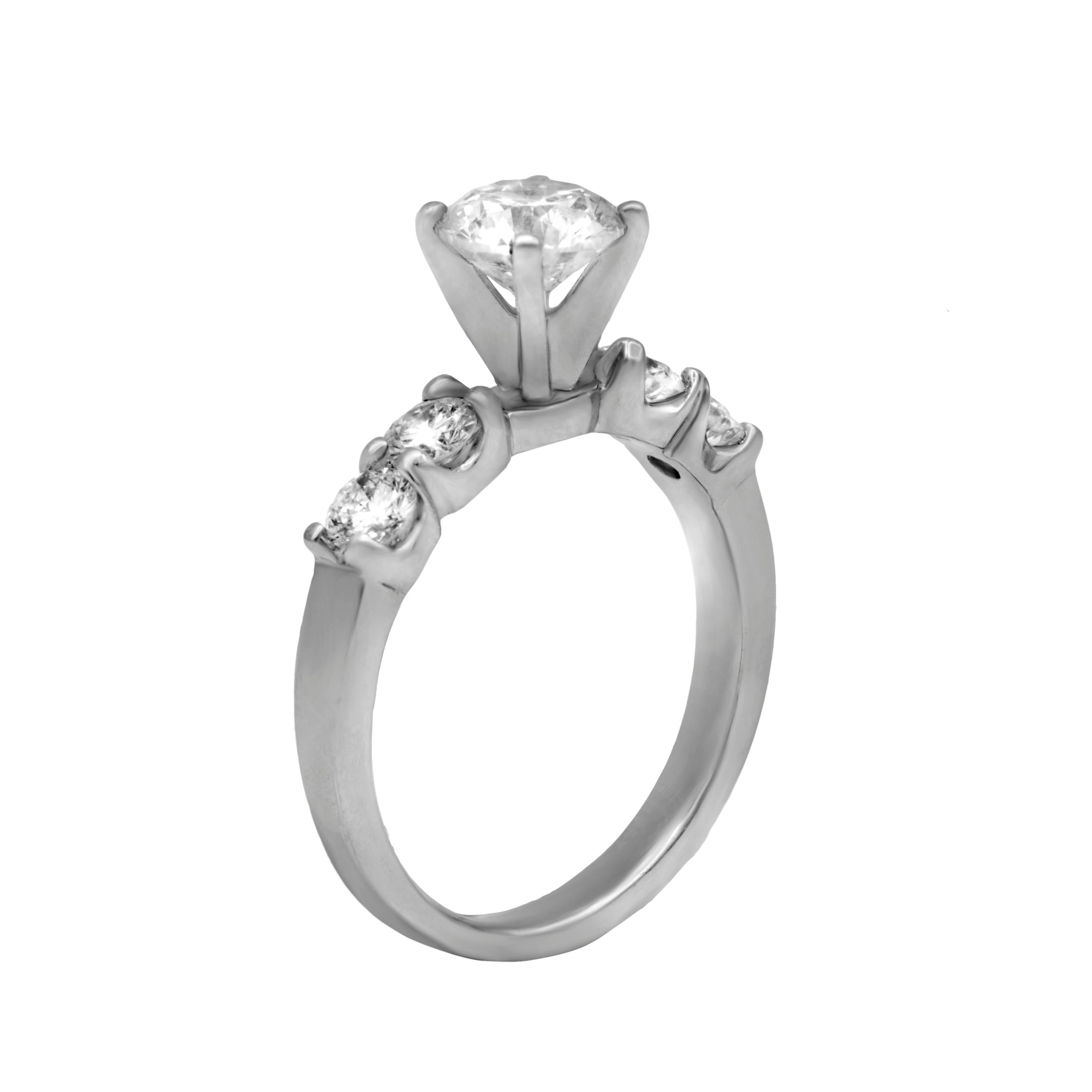 Plat engagement ring, feature 1.01ct round diamond with .55cts of diamonds in a setting.
