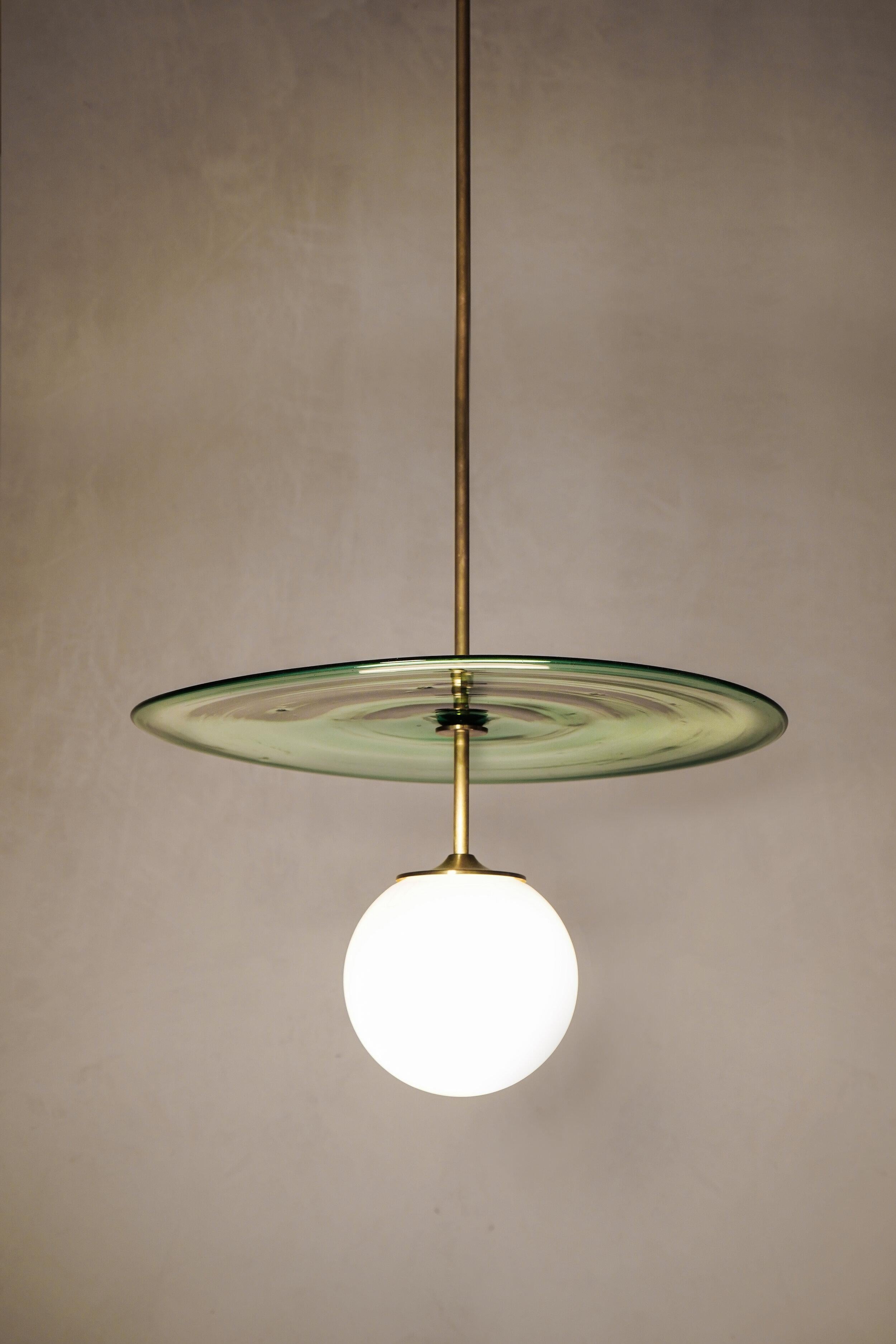 Plat pendant 40/42 by Contain
Dimensions: D 42 x H 100 cm (custom length).
Materials: Brass structure, opal glass and blown glass from local production.
Available in different finishes. Available in two diferents diameters: 40/42 cm Ø x (custom