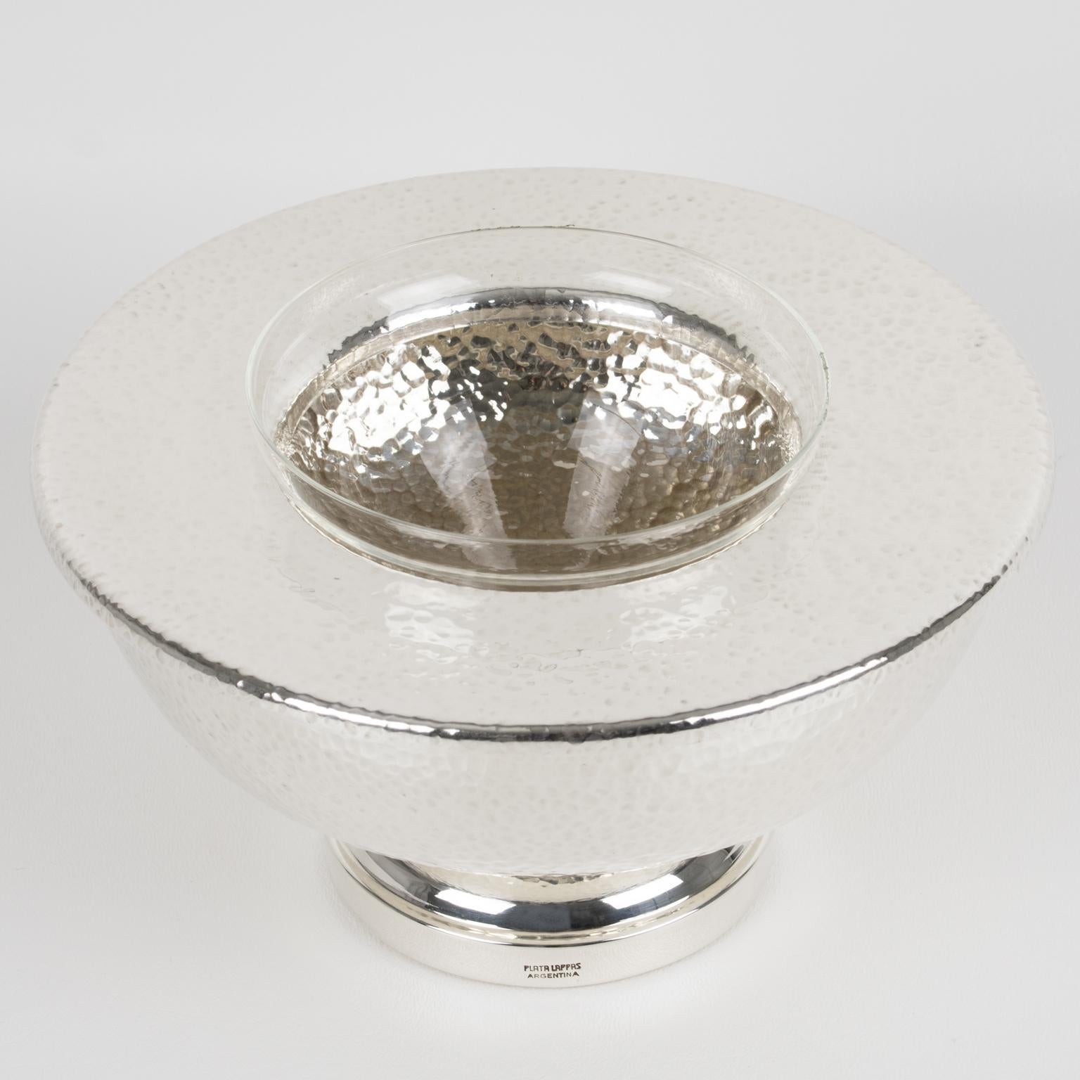 A modernist silver plate and crystal caviar serving bowl, dish, or chiller designed by Argentina silversmith Plata Lappas in the 1980s. The sophisticated design has a streamlined shape and features a rounded silver-plated metal ice container with a