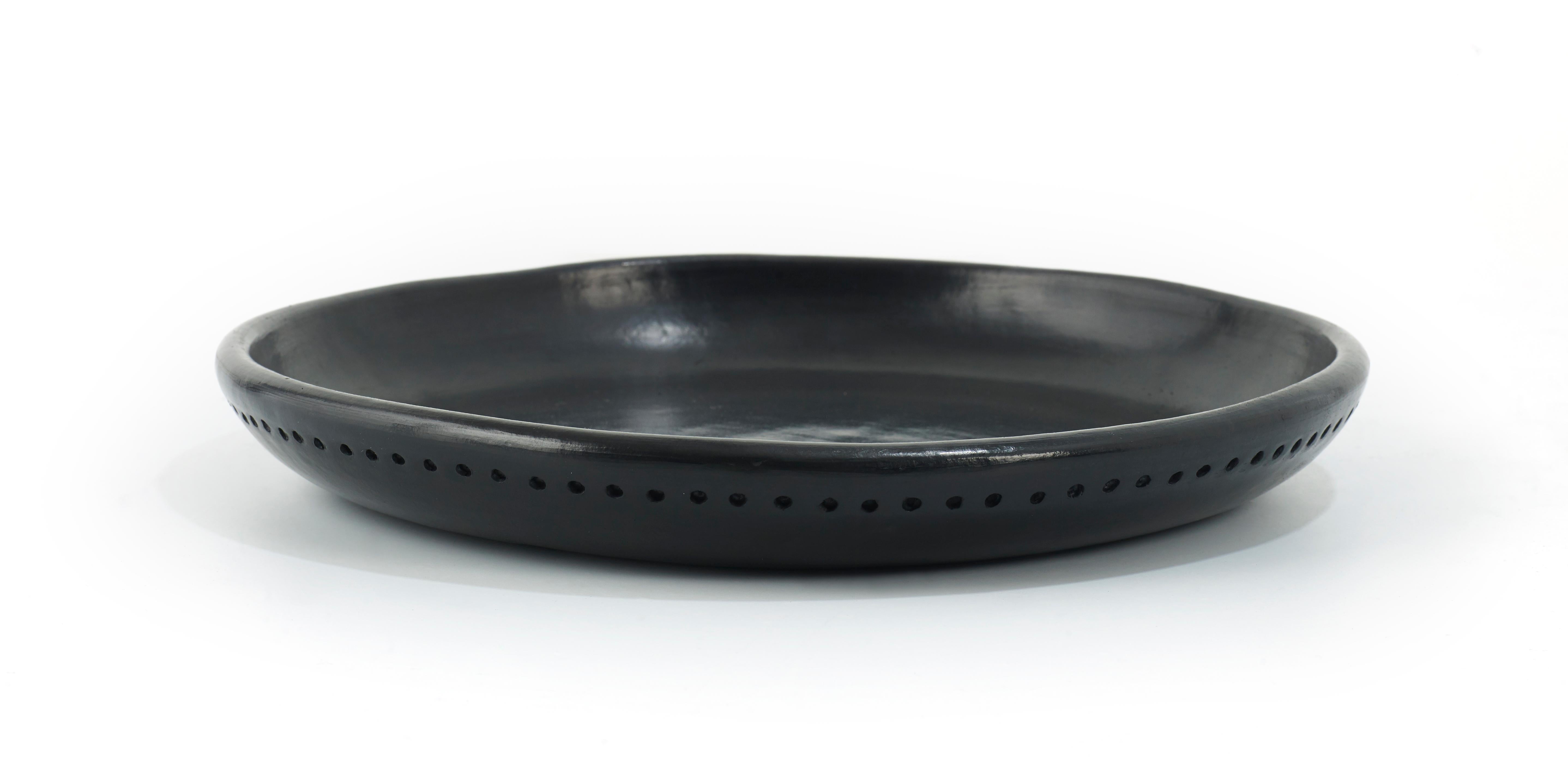 Plate 5 Bowl Barro dining by Sebastian Herkner
Materials: Heat-resistant Black ceramic. 
Technique: Glazed. Oven cooked and polished with semi-precious stones. 
Dimensions: Diameter 29 cm x H 3 cm 
Available in other sizes.

This plate belongs