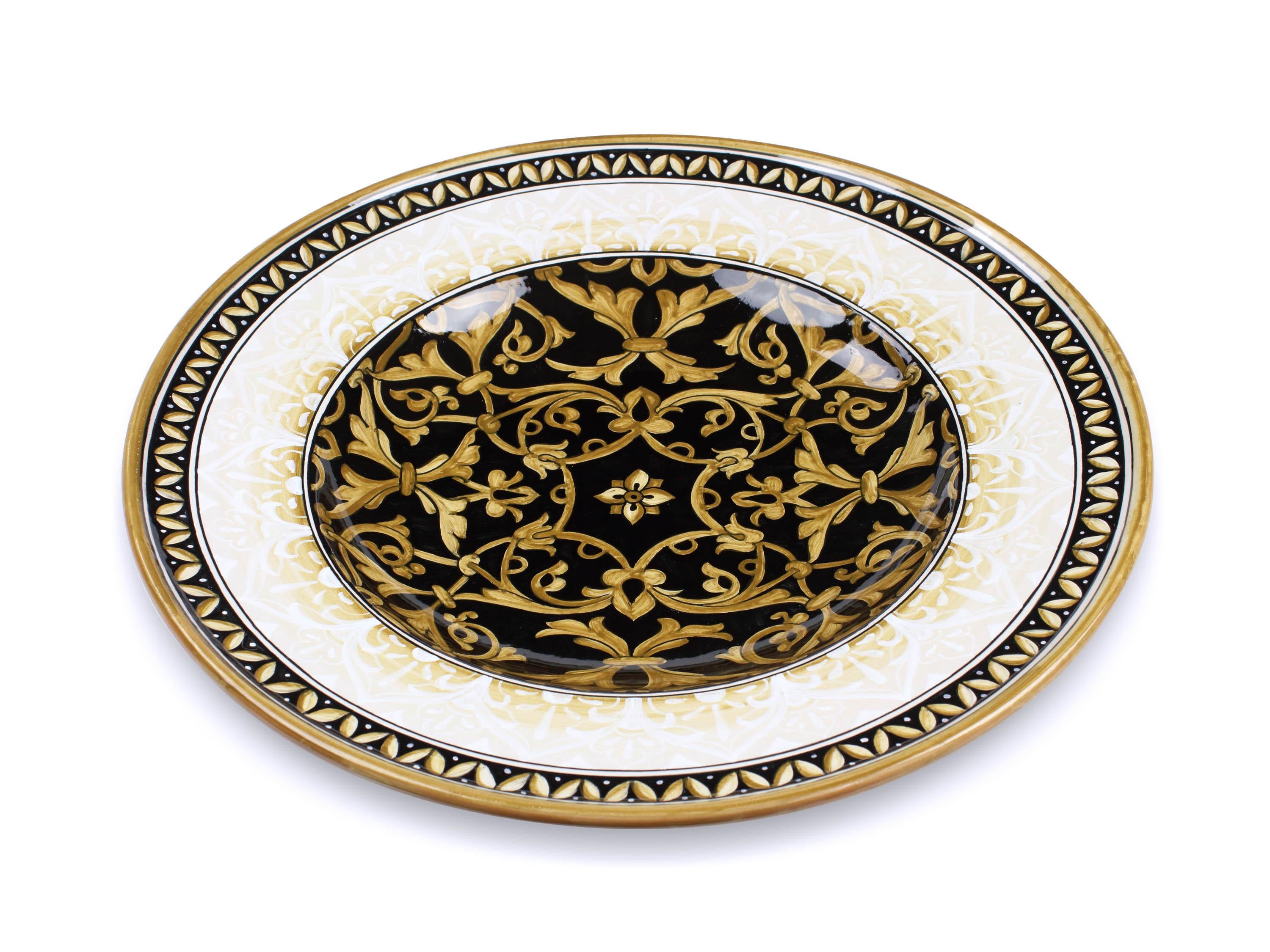 This exclusive ceramic plate is handmade and hand-painted in Italy following the original Renaissance painting technique, unchanged over time, which we observe to the letter: it is decorated in majolica hand-painted in duotone of black and golden