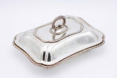 Plate covered in smooth silver with raised friezes on the edges