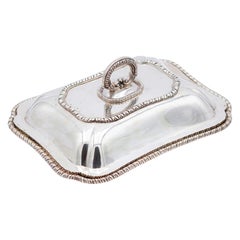 Plate covered in smooth silver with raised friezes on the edges