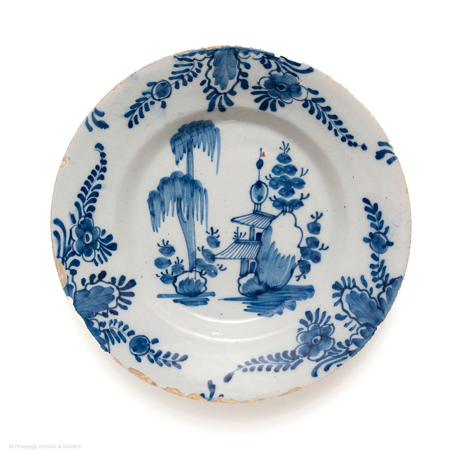 Beautiful bold painting showing the European interpretation of China and the exotic landscape.

Painted with a chinoiserie landscape scene with a pagoda in a wooded garden. The rim painted with three repeats of floral and rocky sprays. Painted in