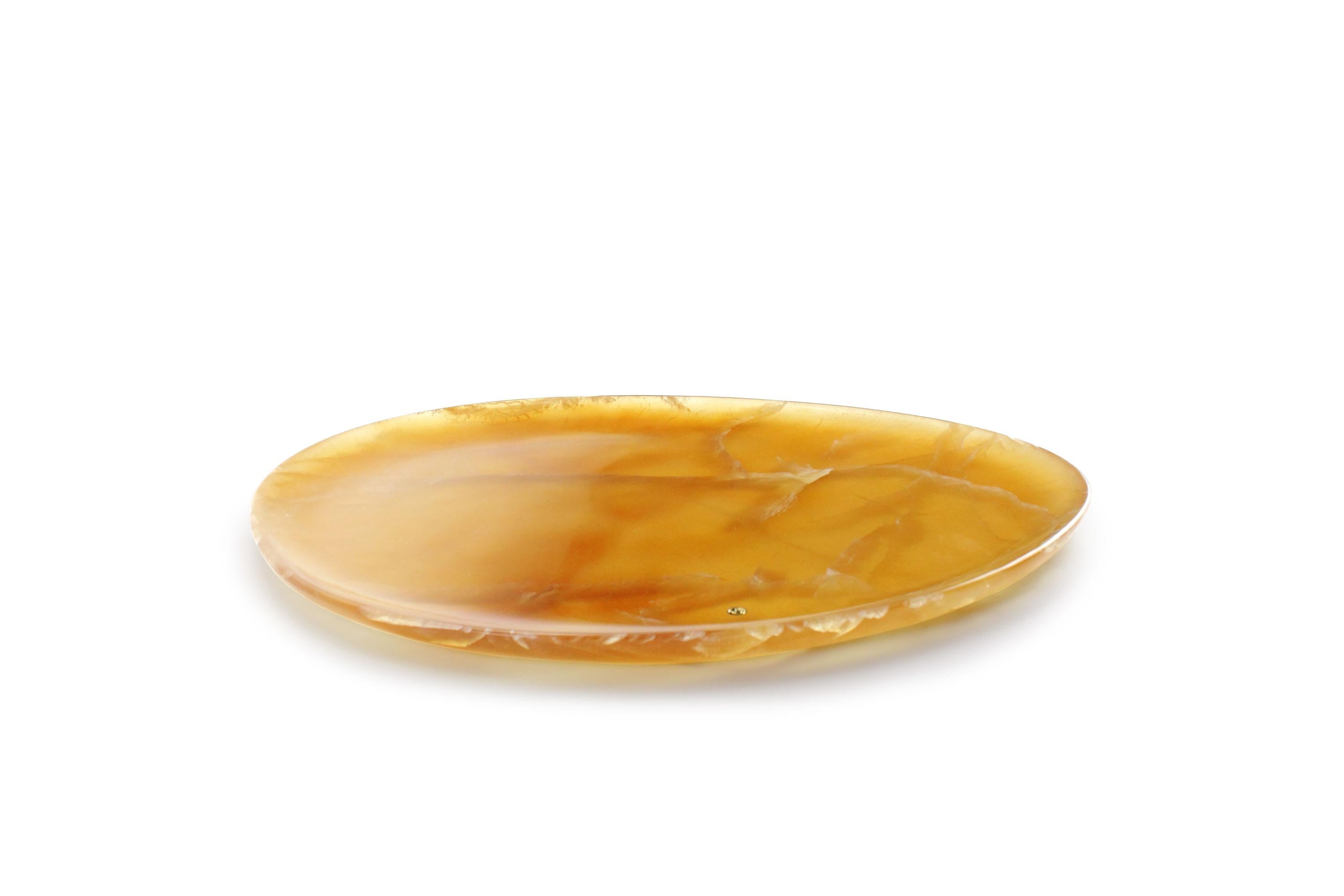 Hand carved presentation plate from Amber onyx. Multiple use as plates, platters and placers. The polished finishing underlines the transparency of the onyx making this a very precious object. 

Dimensions: Big L 36, W 35, H 1.8 cm, also available: