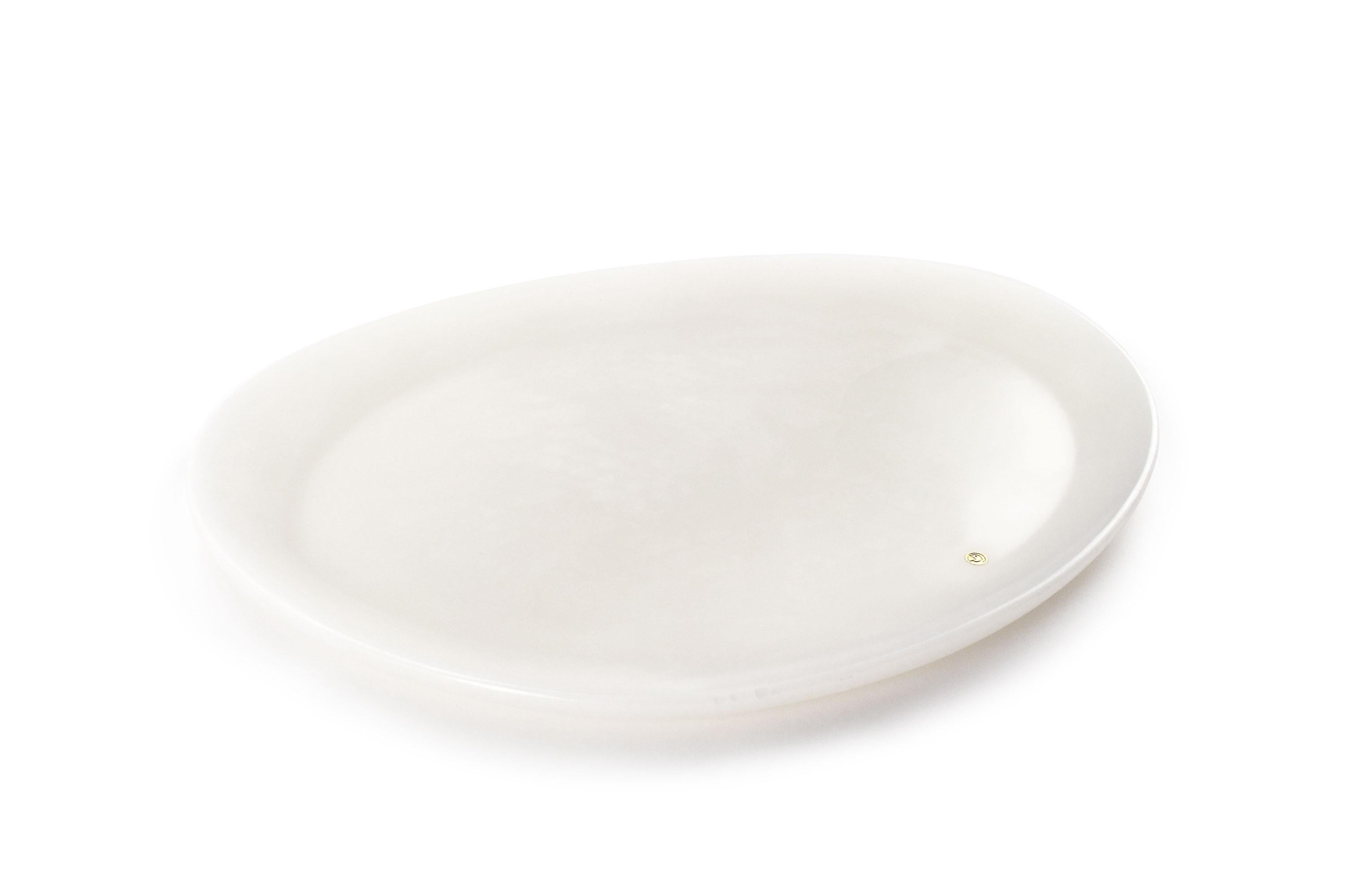 Hand carved presentation plate from White onyx. Multiple use as plates, platters and placers. The polished finishing underlines the transparency of the onyx making this a very precious object. 

Dimensions: Big L 36, W 35, H 1.8 cm, also available: