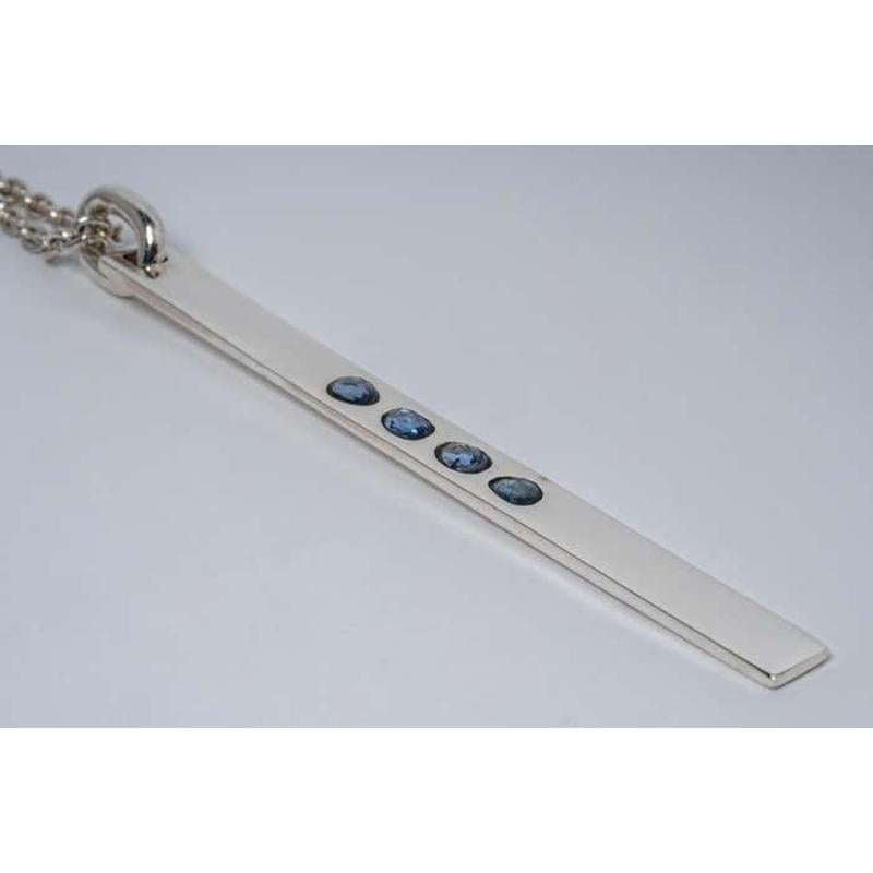 Spike necklace in polished sterling silver and a slab of blue sapphire faceted slab. This slab is removed from a larger chunk of sapphire, it comes on a 74cm chain. This item is made with a naturally occurring element and will vary from the