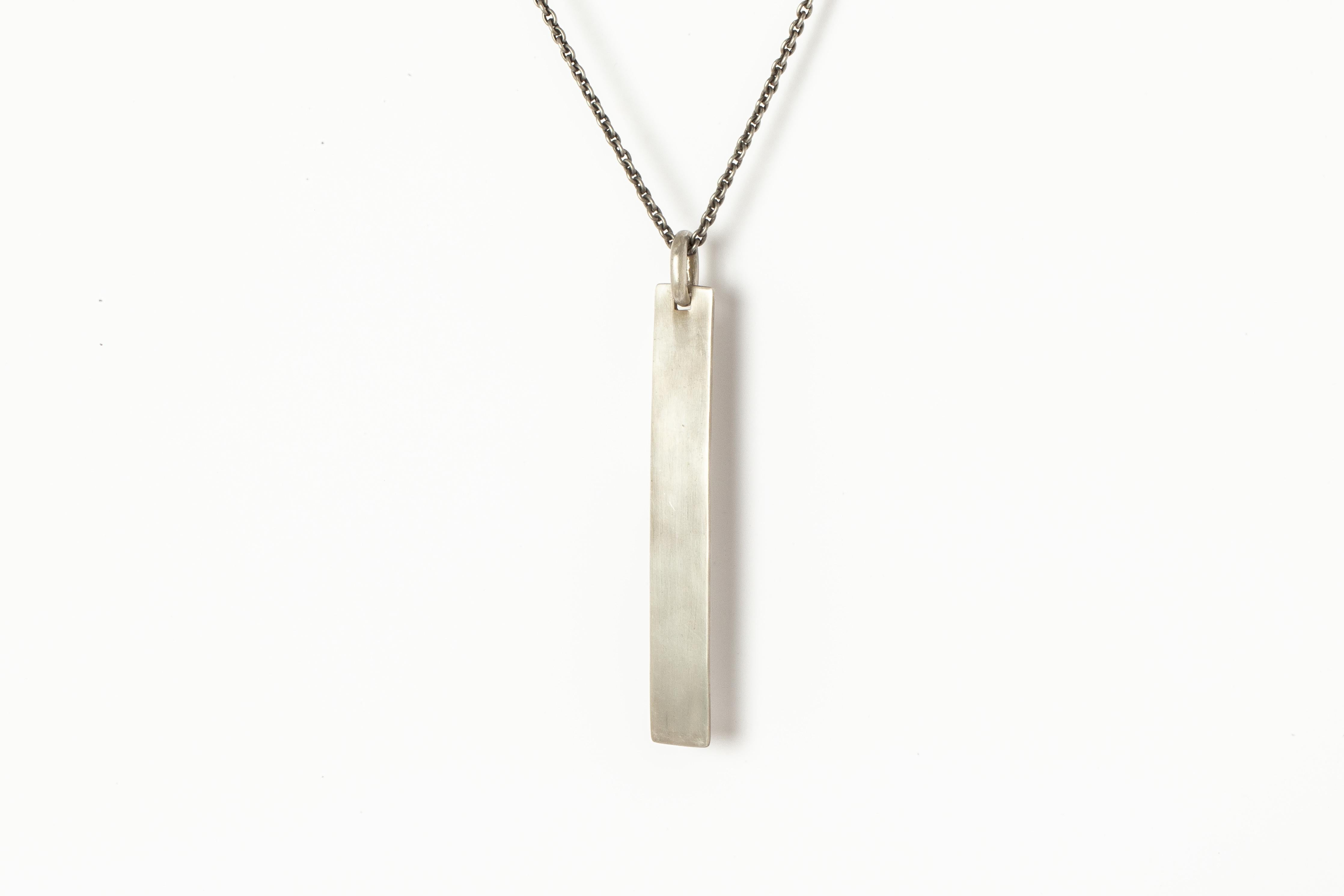 Plate necklace in brass, it comes on a 74cm chain. Brass substrate is electroplated with silver and then dipped into acid to create the subtly destroyed surface.