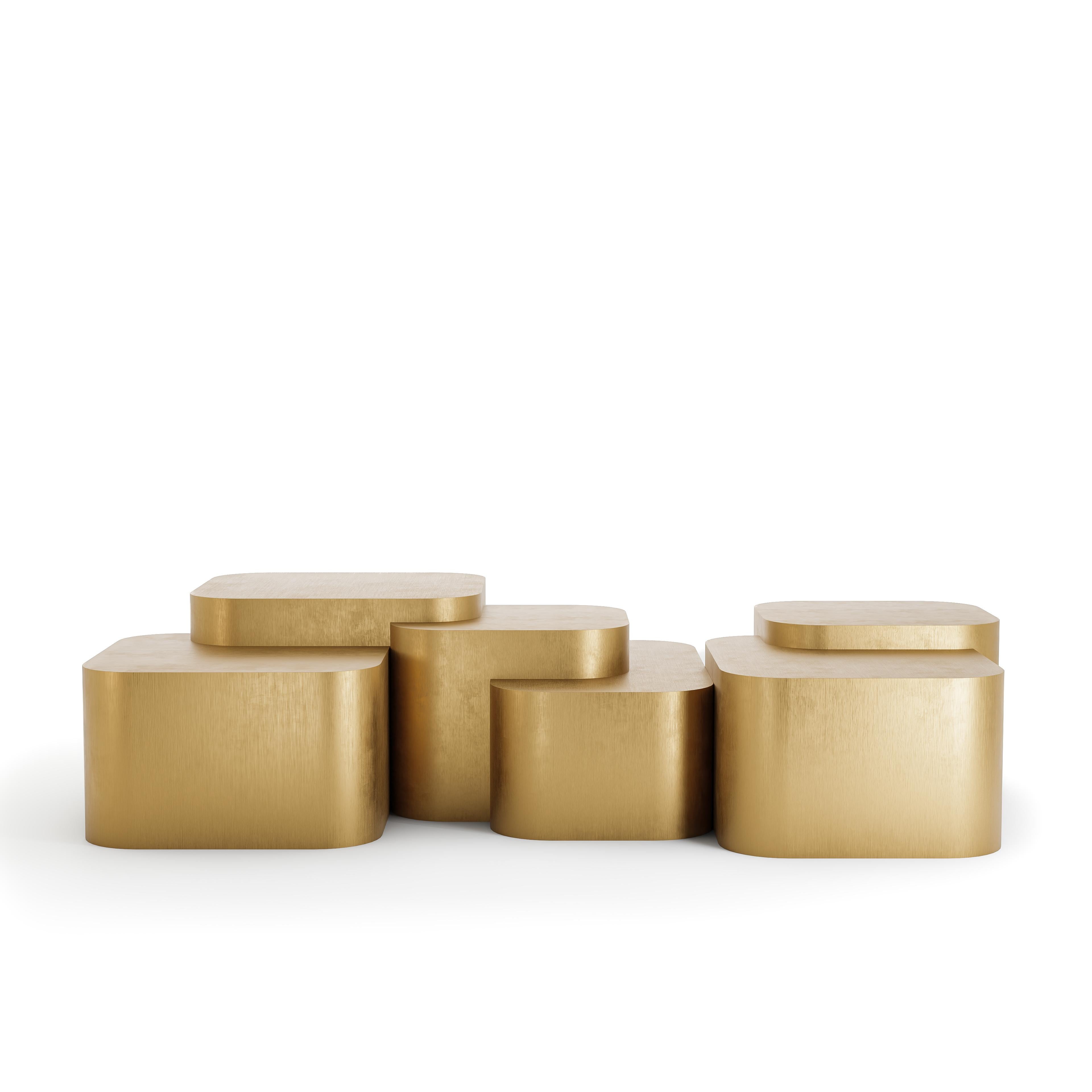 Handcrafted with a solid wood core and finished in hand-applied brushed brass sheets, the Platea Metalica coffee table draws inspiration from natural plateaus and stepped landscapes. Its six-tiered, staggered composition evokes a sense of rhythmic