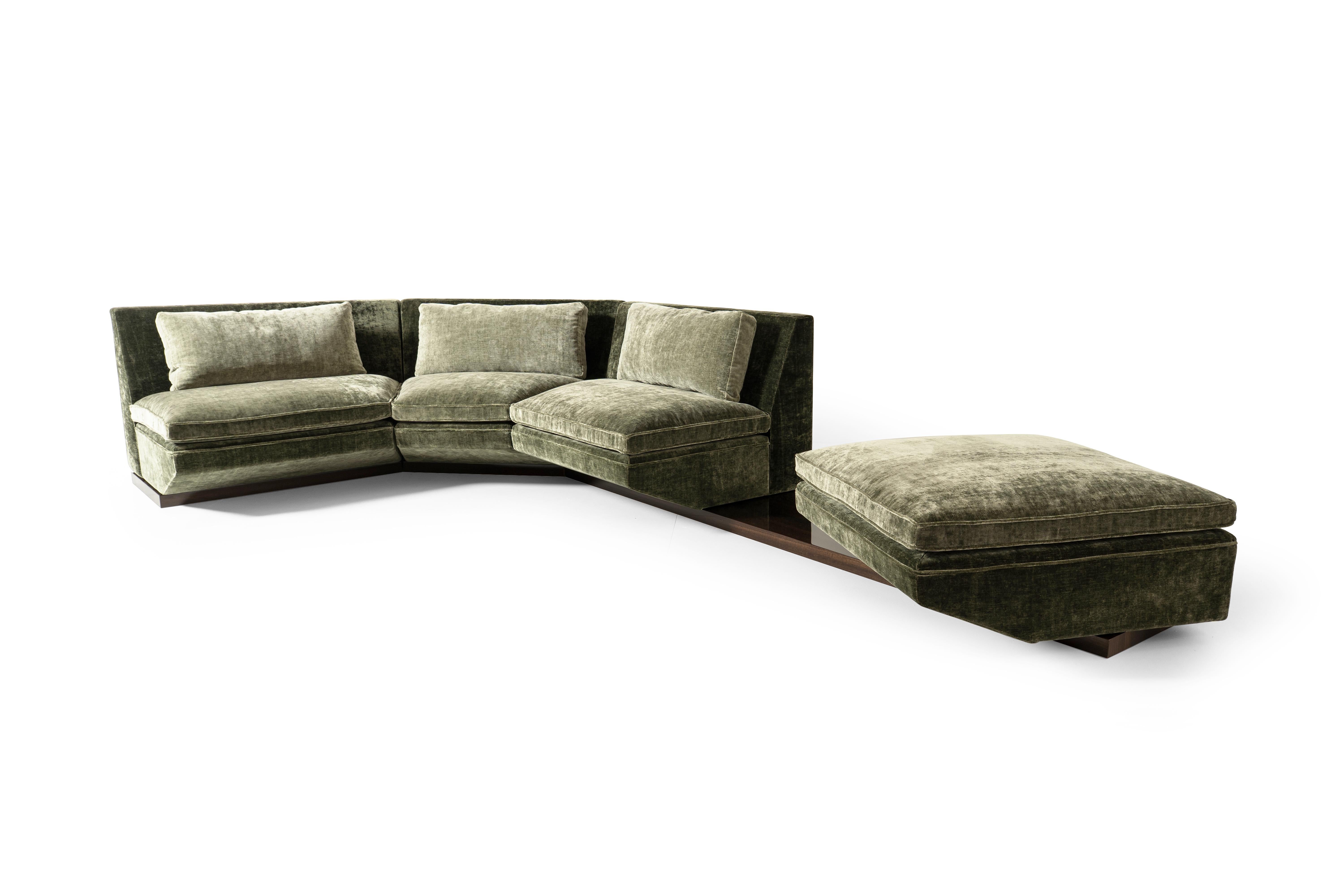 Platea is a modular sofa with a sculptural and functional character. The seat conveys a feeling of enveloping comfort, as does the high-gloss polyester lacquer eucalyptus wood base resulting in a visual effect based on consistency and contemporary