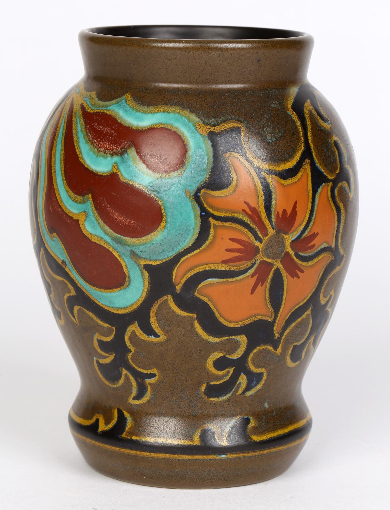 Plateelbakkerij Zuid-Holland (PZH) Dutch Gouda Art Deco hand painted pottery vase in the Silvia design dating from around 1920. The lightly potted earthenware vase is hand painted in coloured enamels with an abstract floral design on a bronze-brown