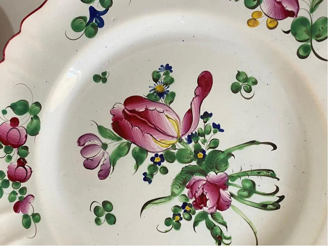 The plates are in Faience. It has been made in France, during the 19th century.
The pattern decor are Flowers, and tha main colors green and red.